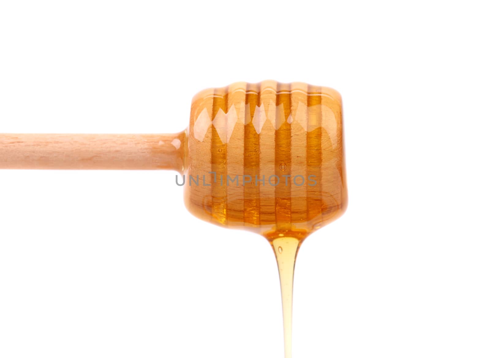honey is dripping from the spoon, cut out from white