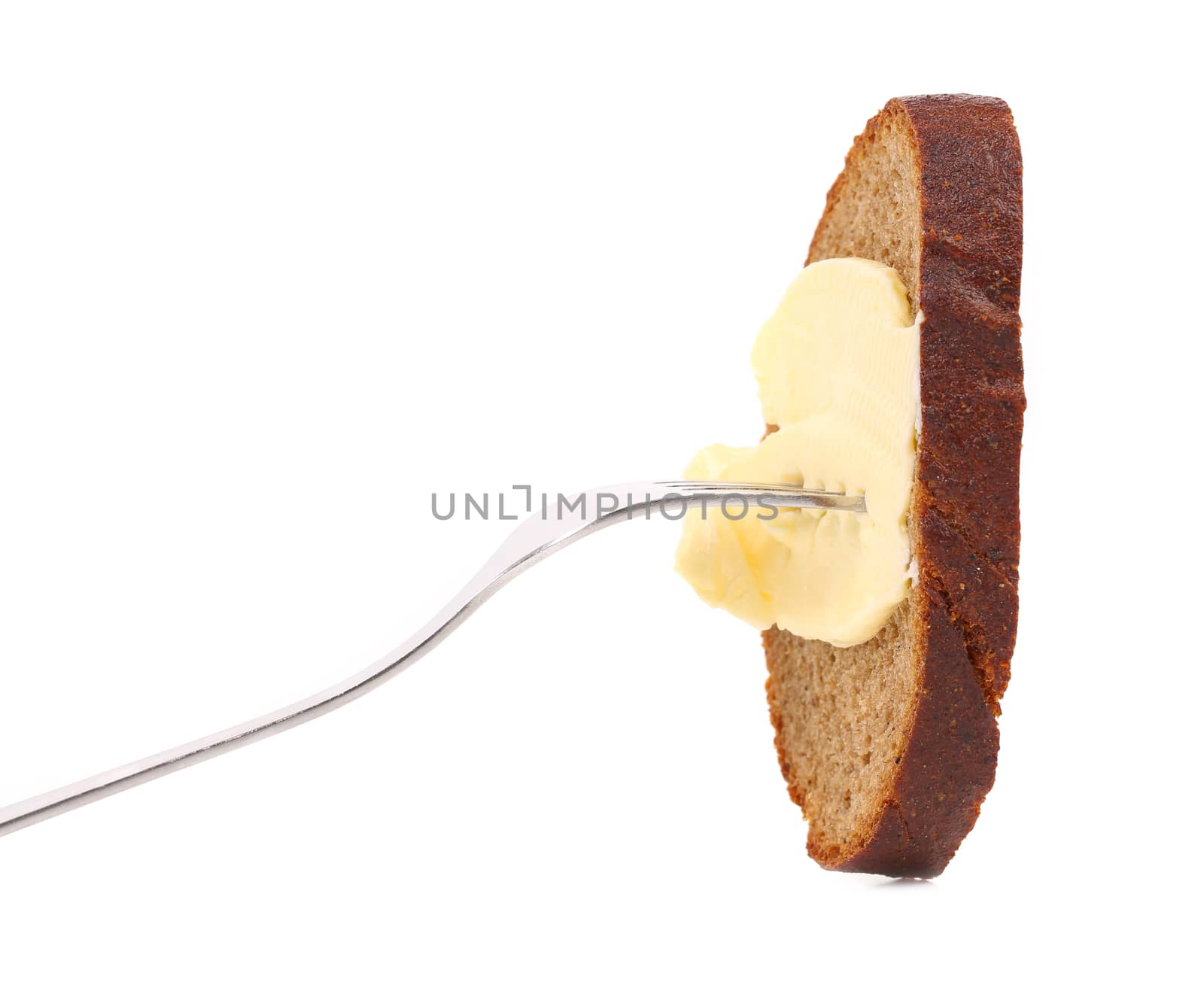 Brown bread and butter on a fork. White background.