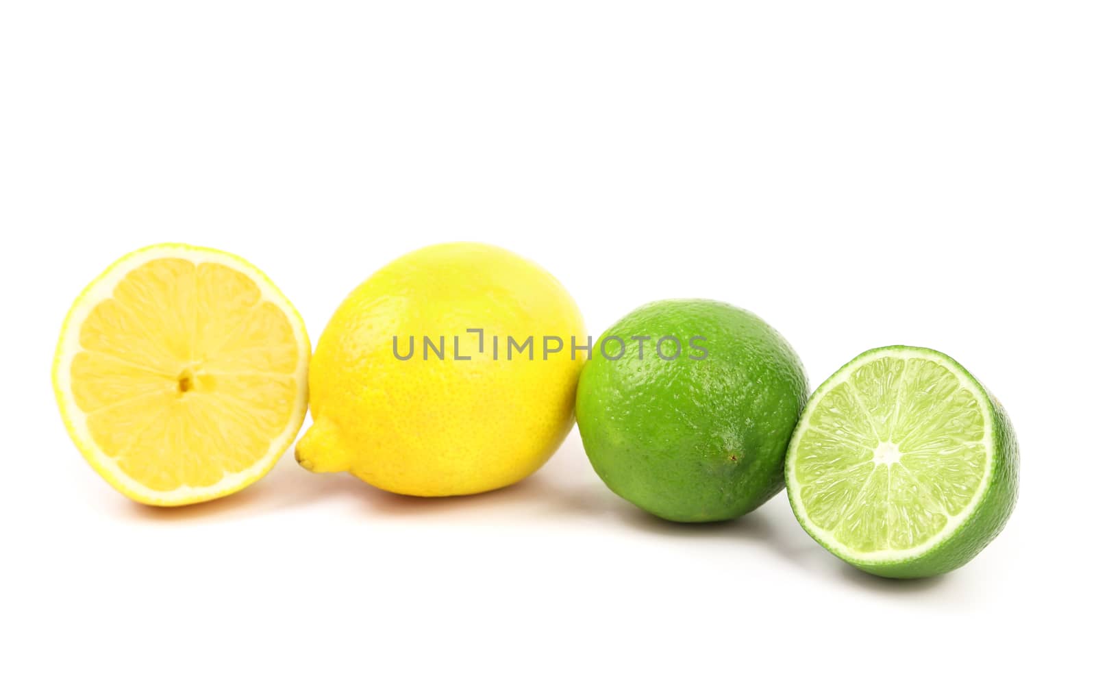Fresh limes and lemons. Slices. White background.