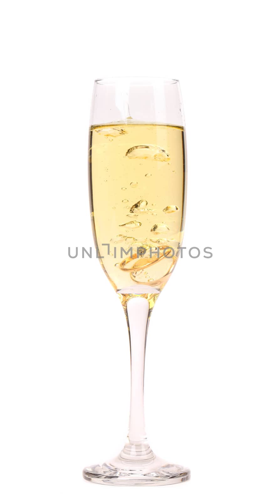 Wedding rings in a glass of champagne. White background.