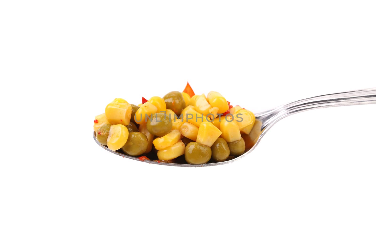 Spoonful with peas and corn isolated on a white background
