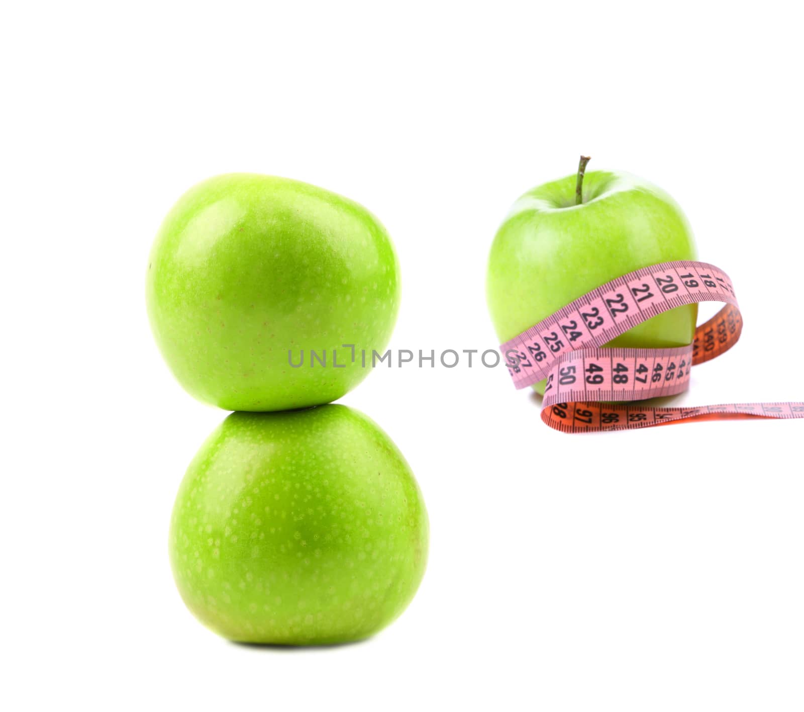 Green apples with tape measure. White background.