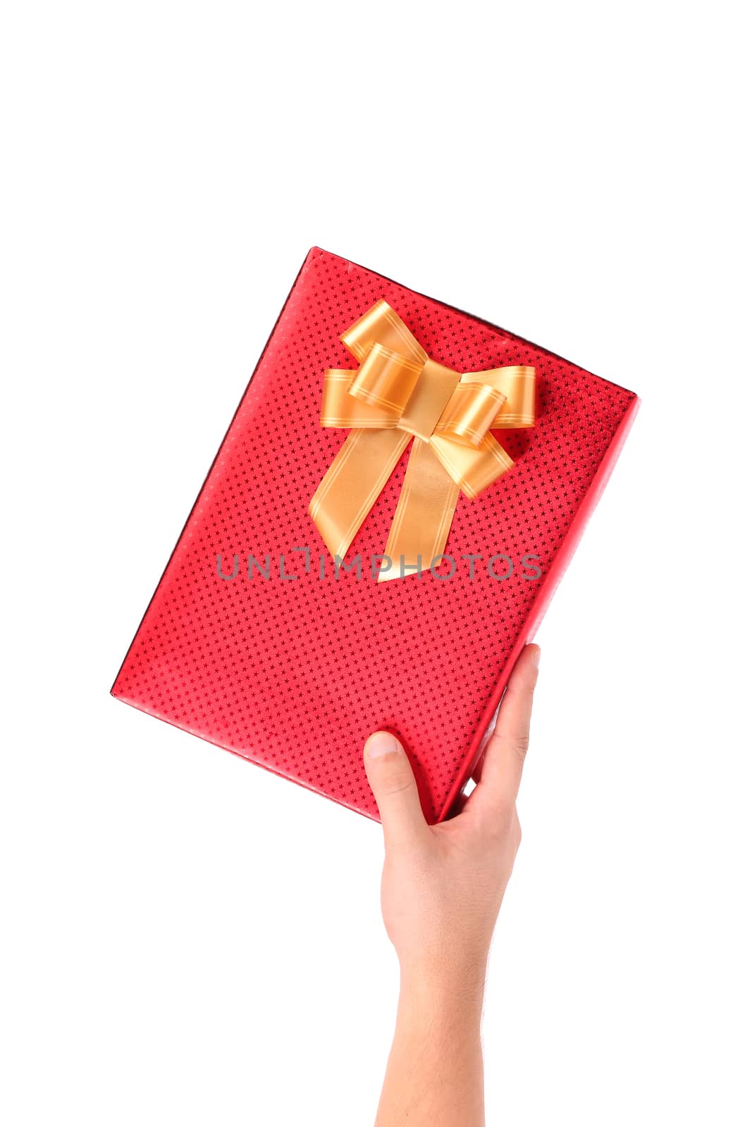 Hand holds a red box with a gold bow studded asterisks