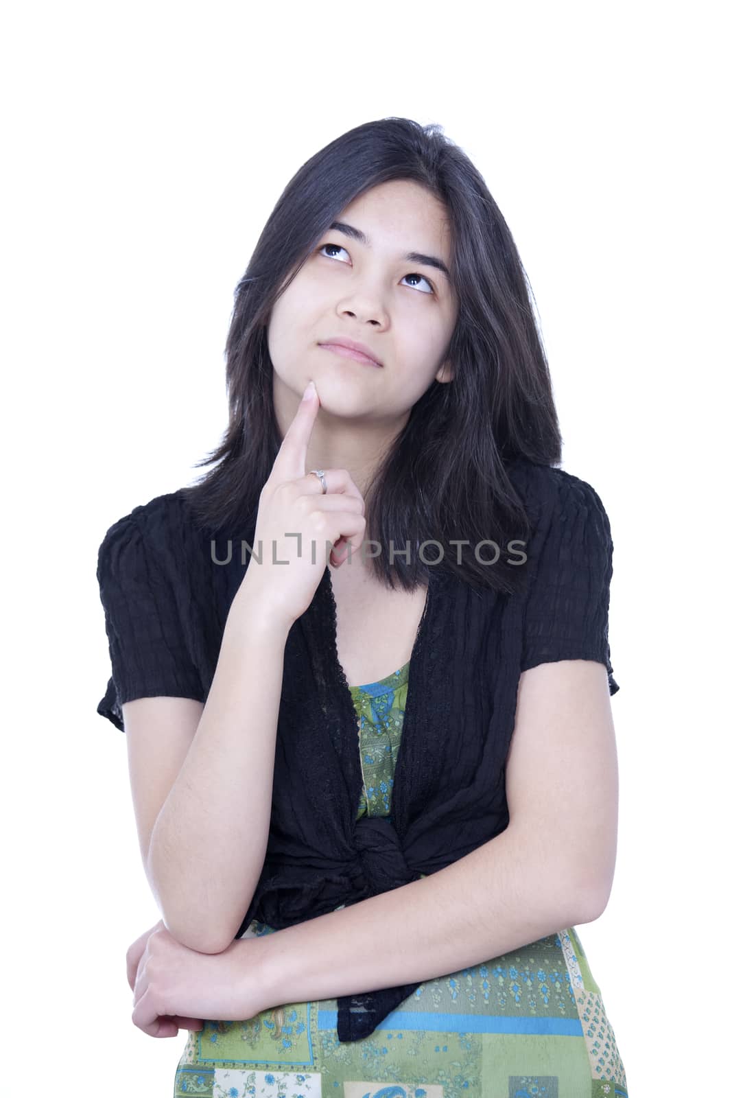 Young teen girl looking up, thinking, finger to chin