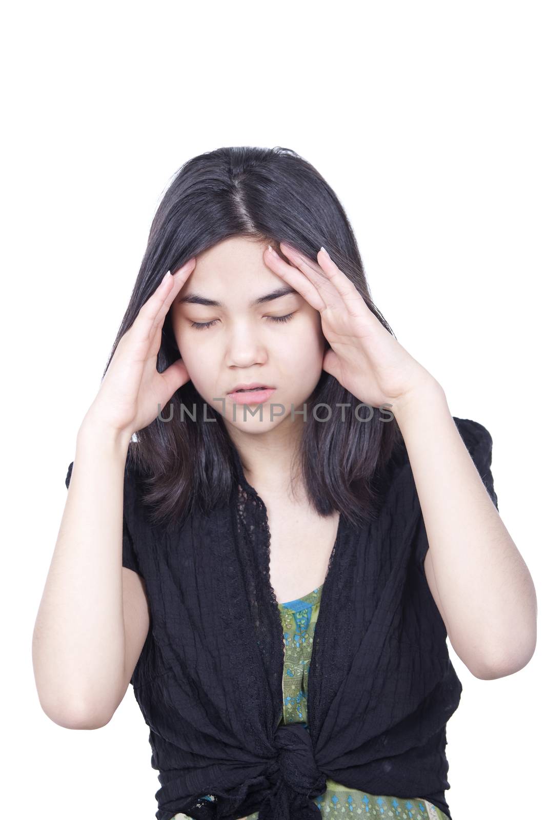 Young biracial teen girl massaging temple, face stressed or havi by jarenwicklund