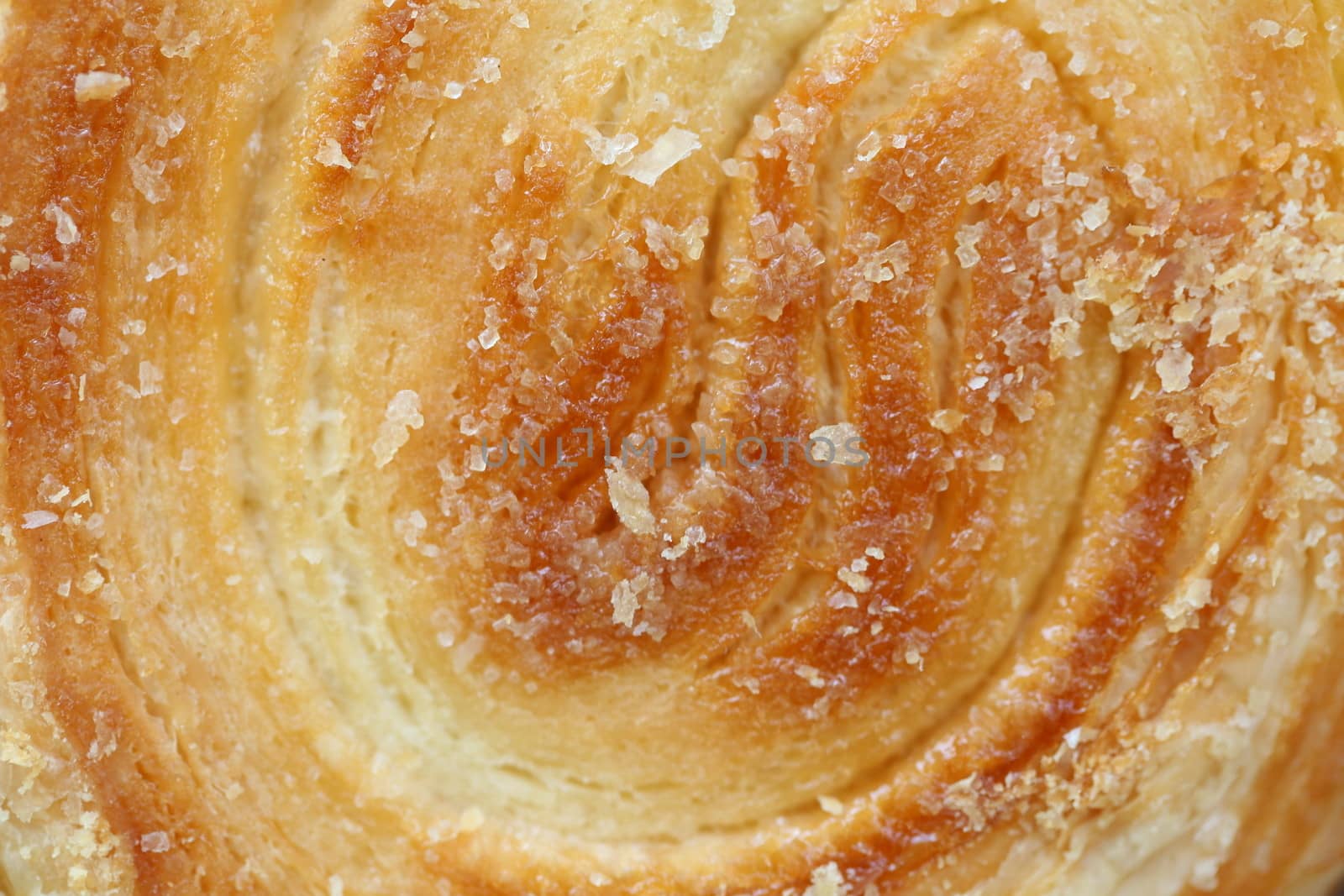 Background of puff pastry with sugar. Close up.