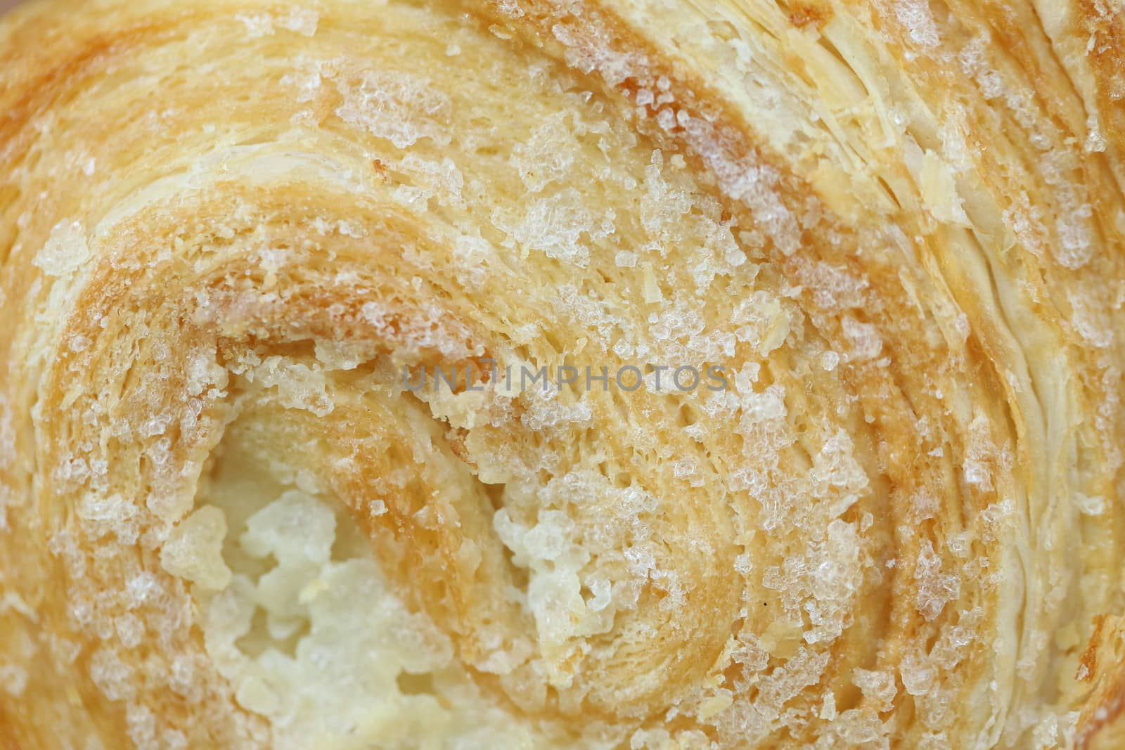 Background of puff pastry with sugar. Close up.