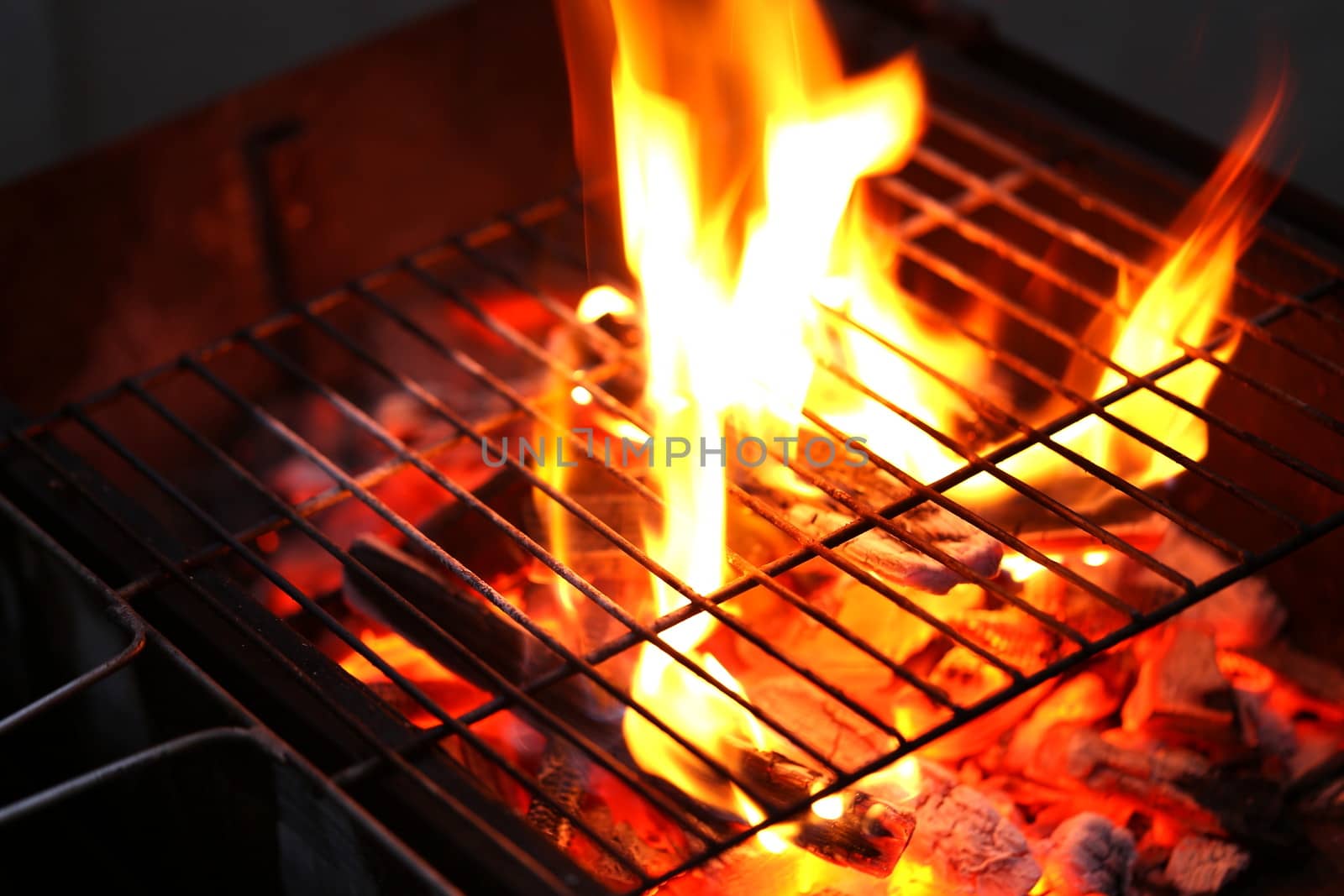 Blazing fire in Grilled. Close up. Whole background.