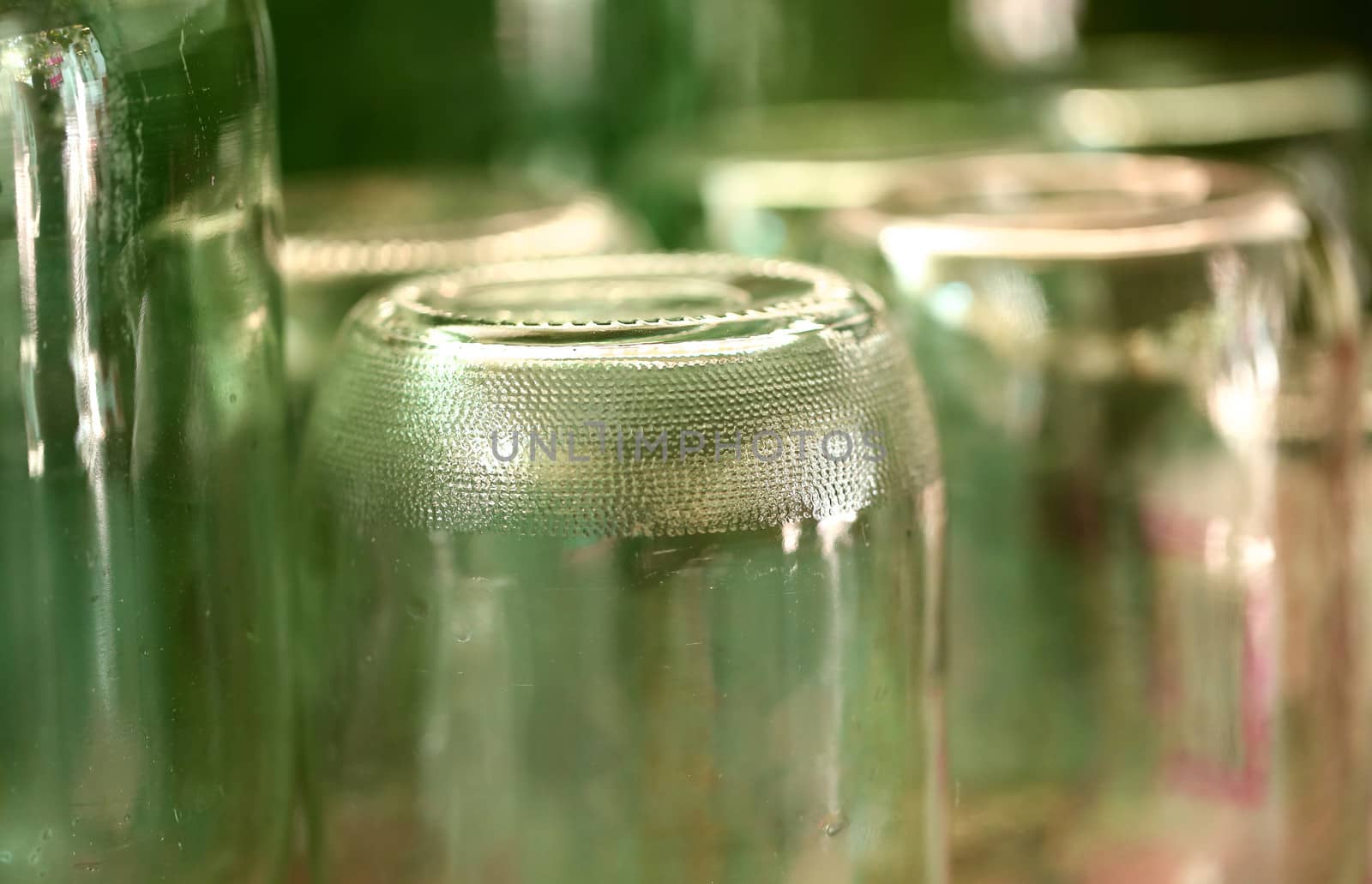 Grooved bottom of glass jar. Blurred background.