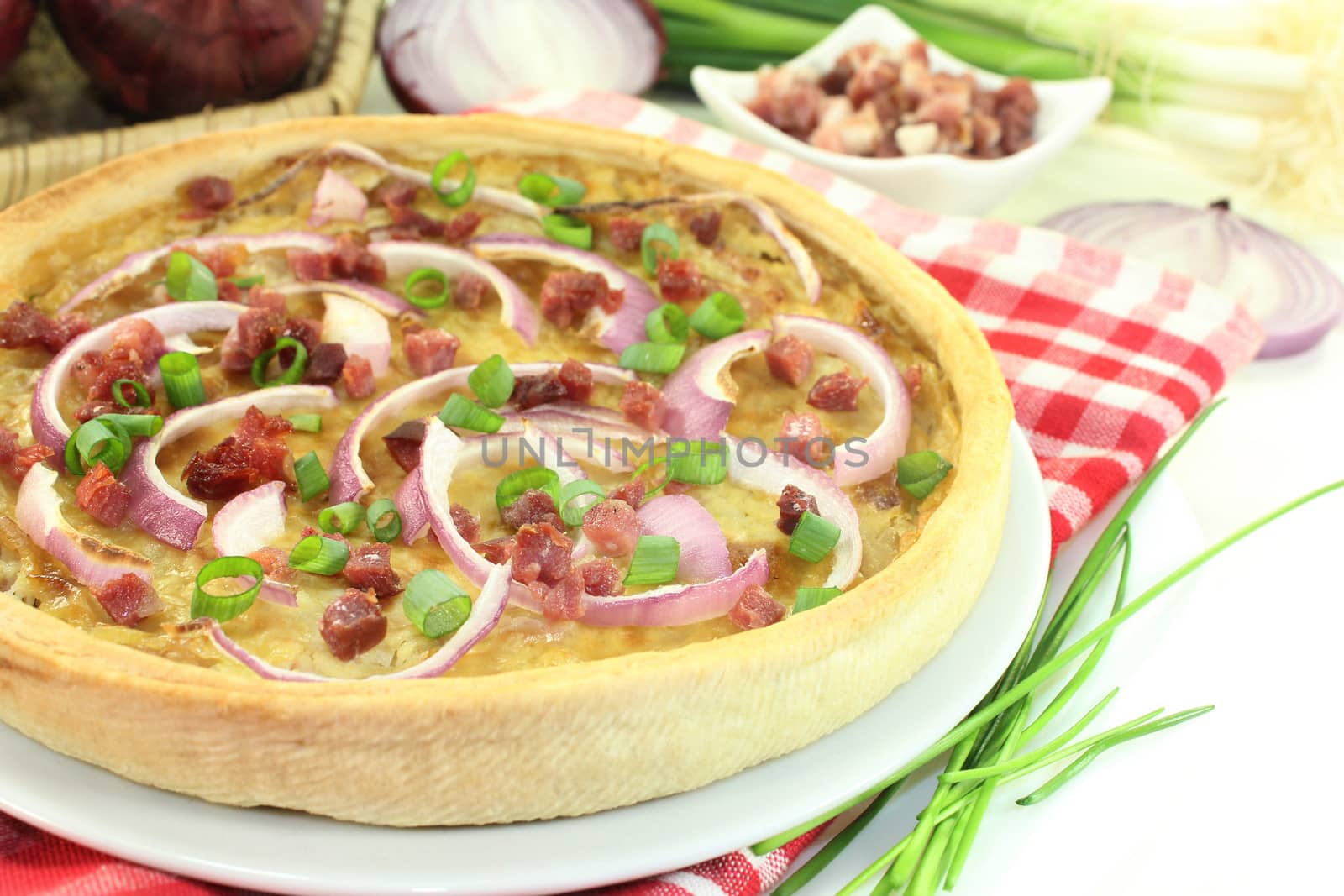 freshly baked onion tart with ham cubes