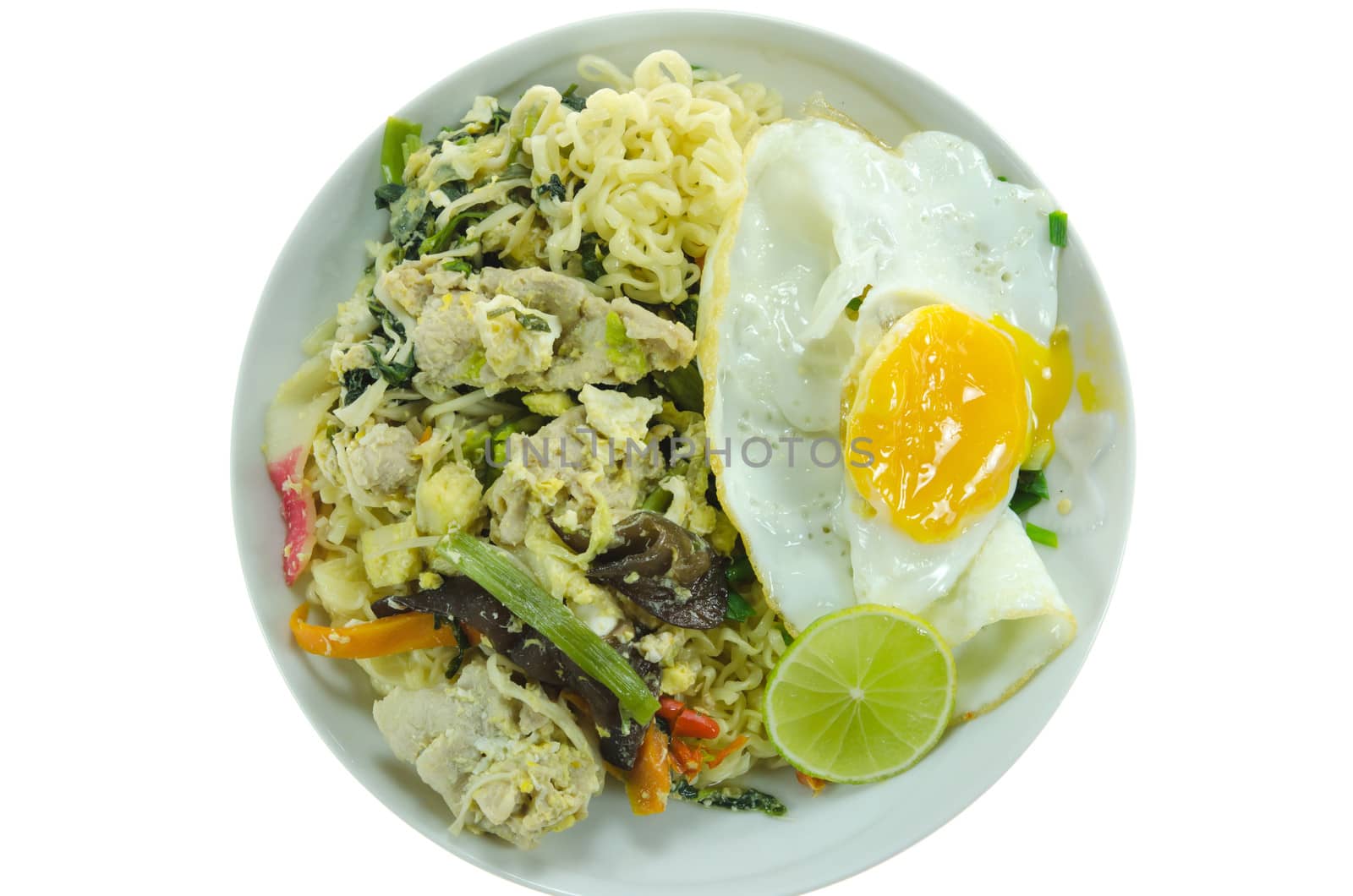 top view stir fried  instant noodles with pork ,  chili , vegetable , slices lime and fried egg  on dish over  white background