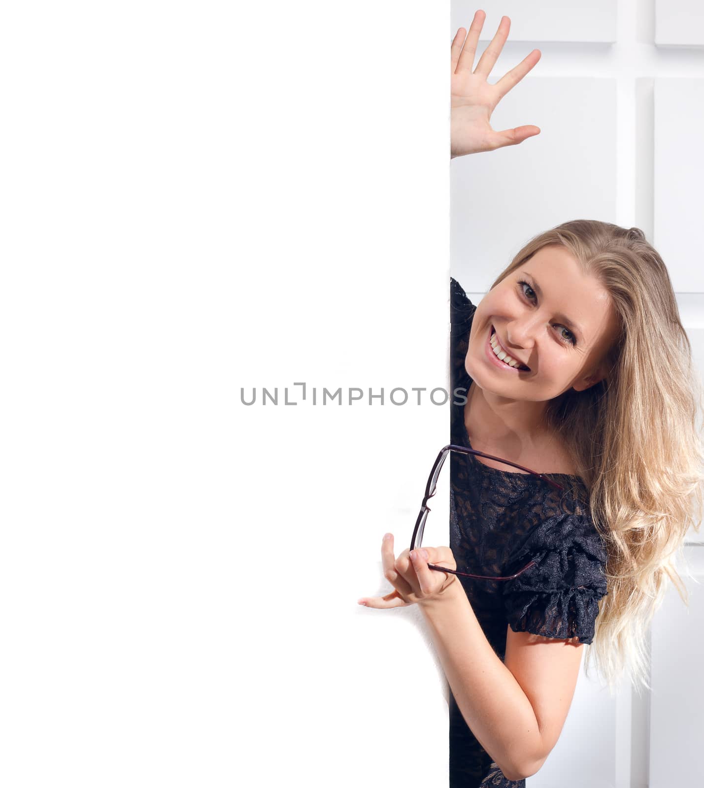 Beautiful woman holding a blank billboard on light background