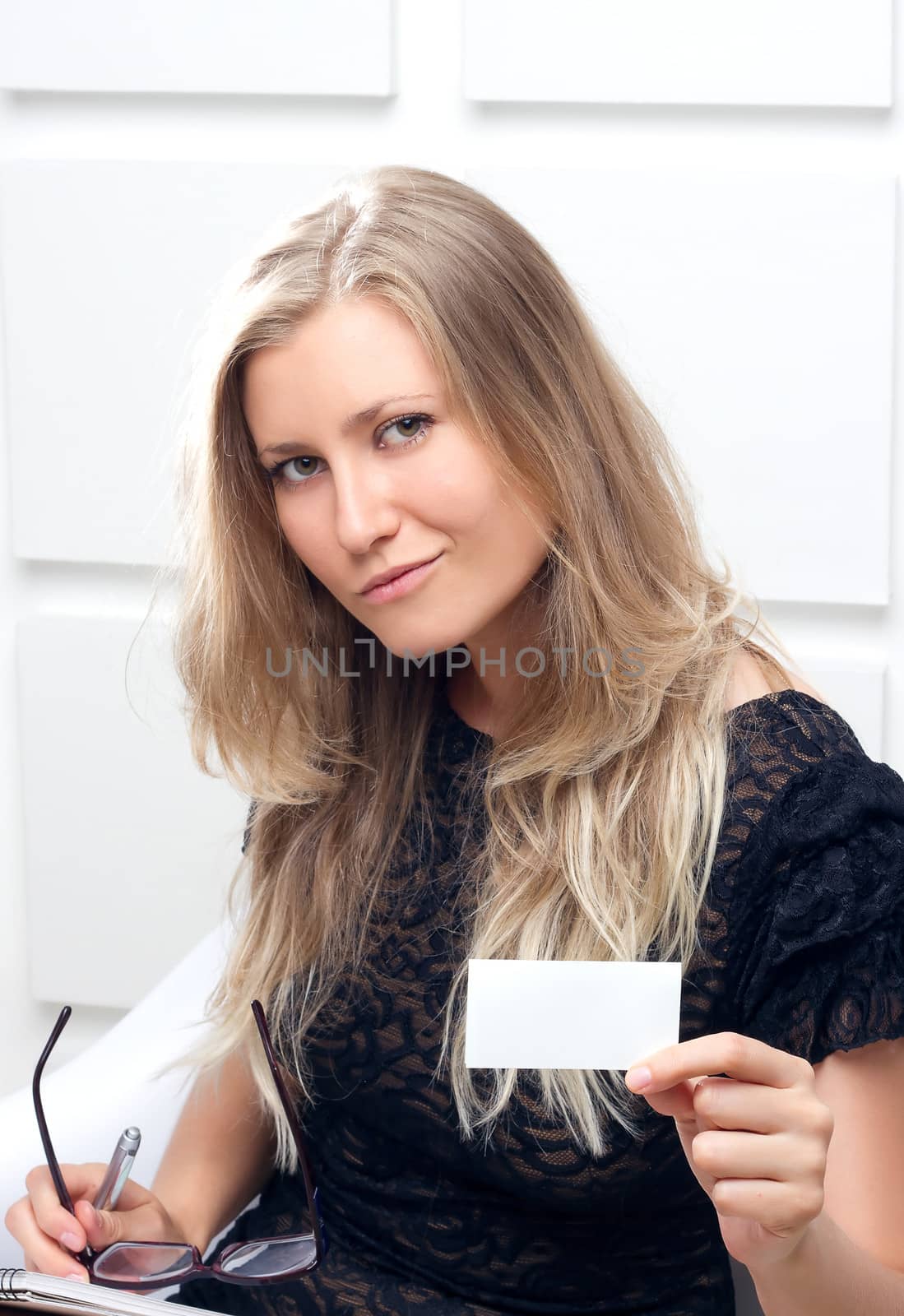 Portrait of smiling business woman giving blank business card