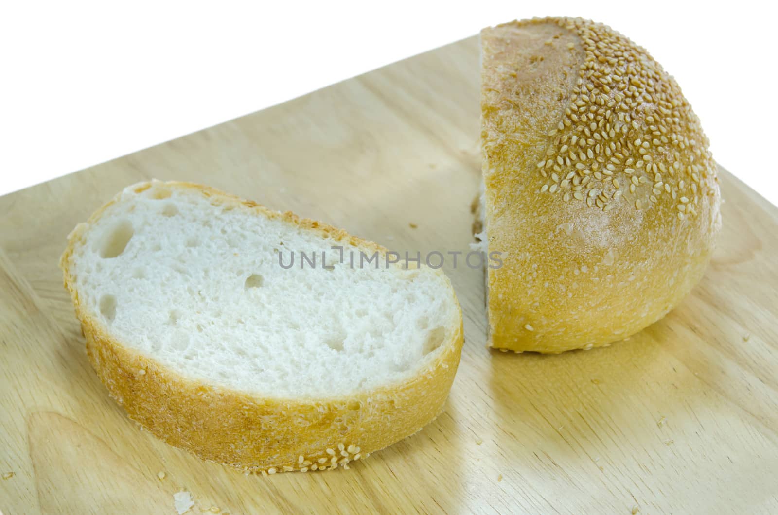 slices  bread with sesame seeds on wooden board over white