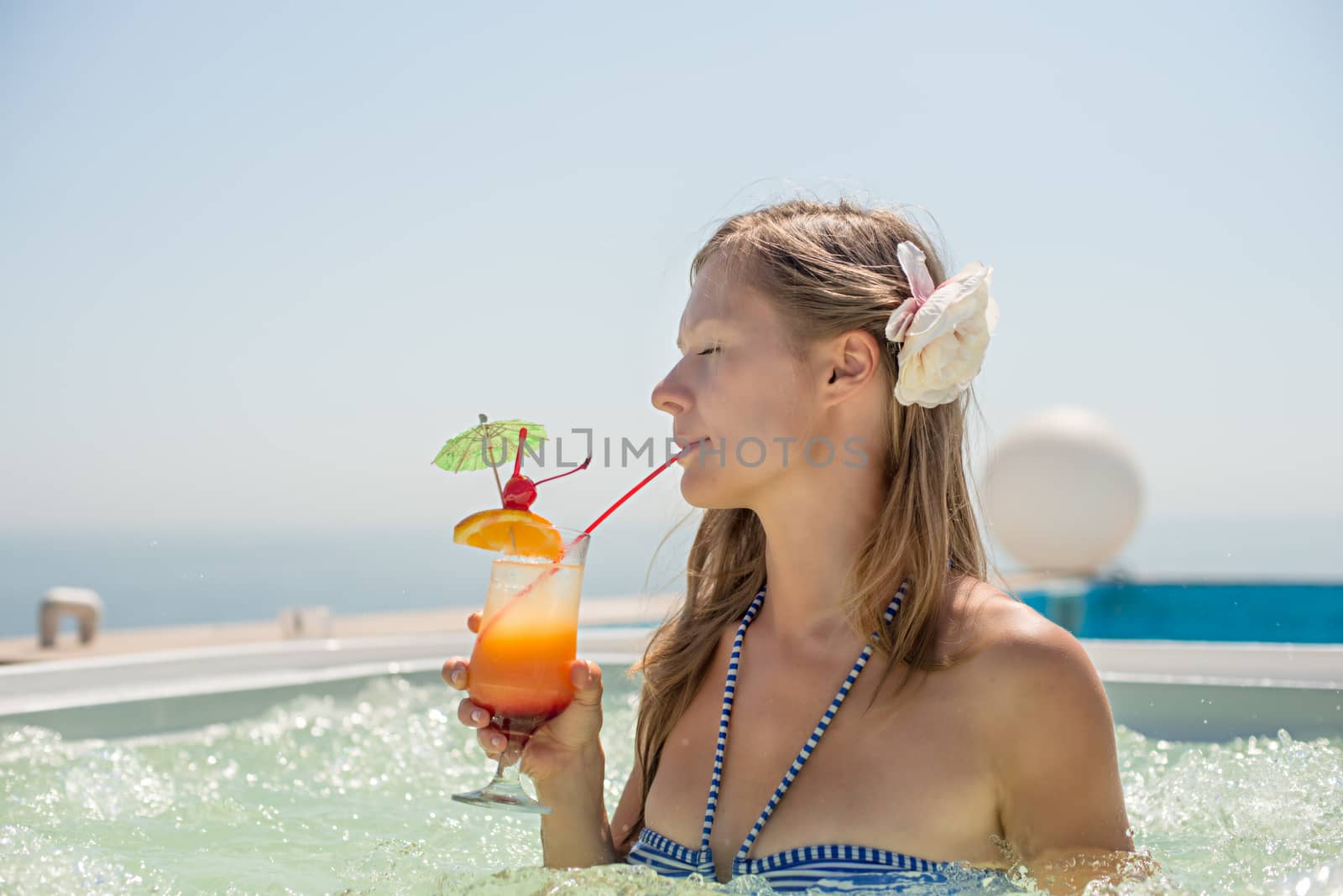 Woman drinking tropical cocktail by Nickolya