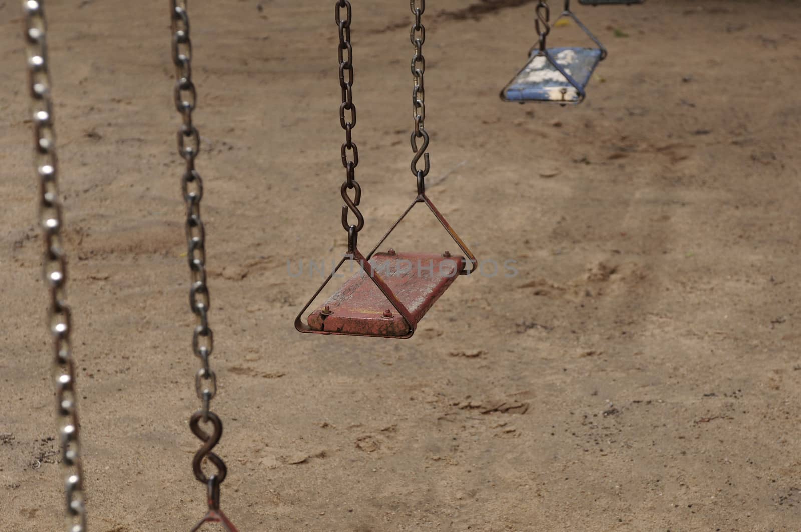 An old swing at abandoned playground by rodrigobellizzi