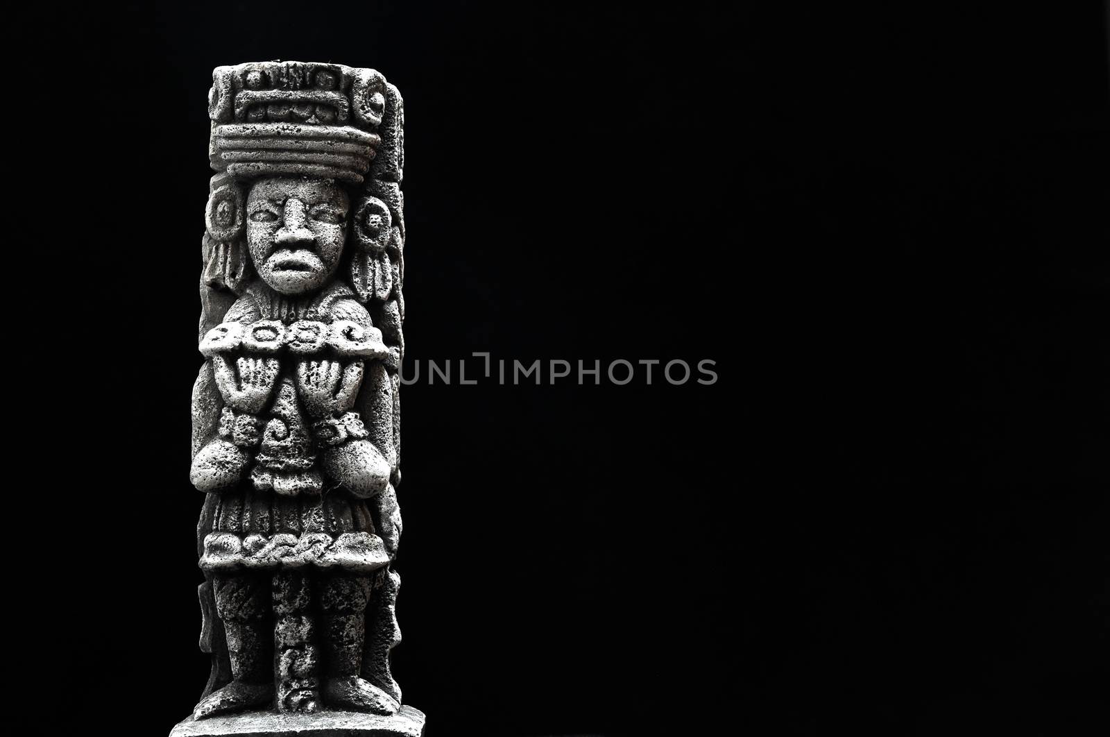 One Ancient Mayan Statue on a Black Background