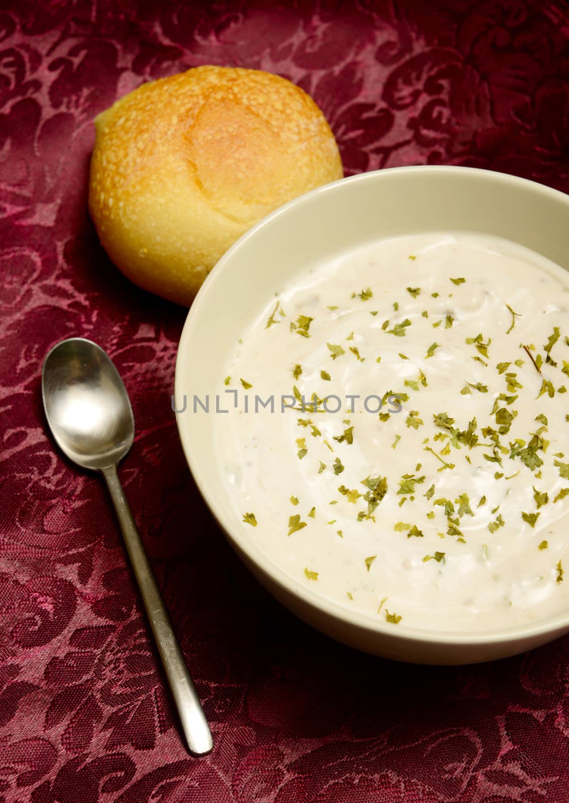 bowl of cream of mushroom soup in autumn with dinner roll