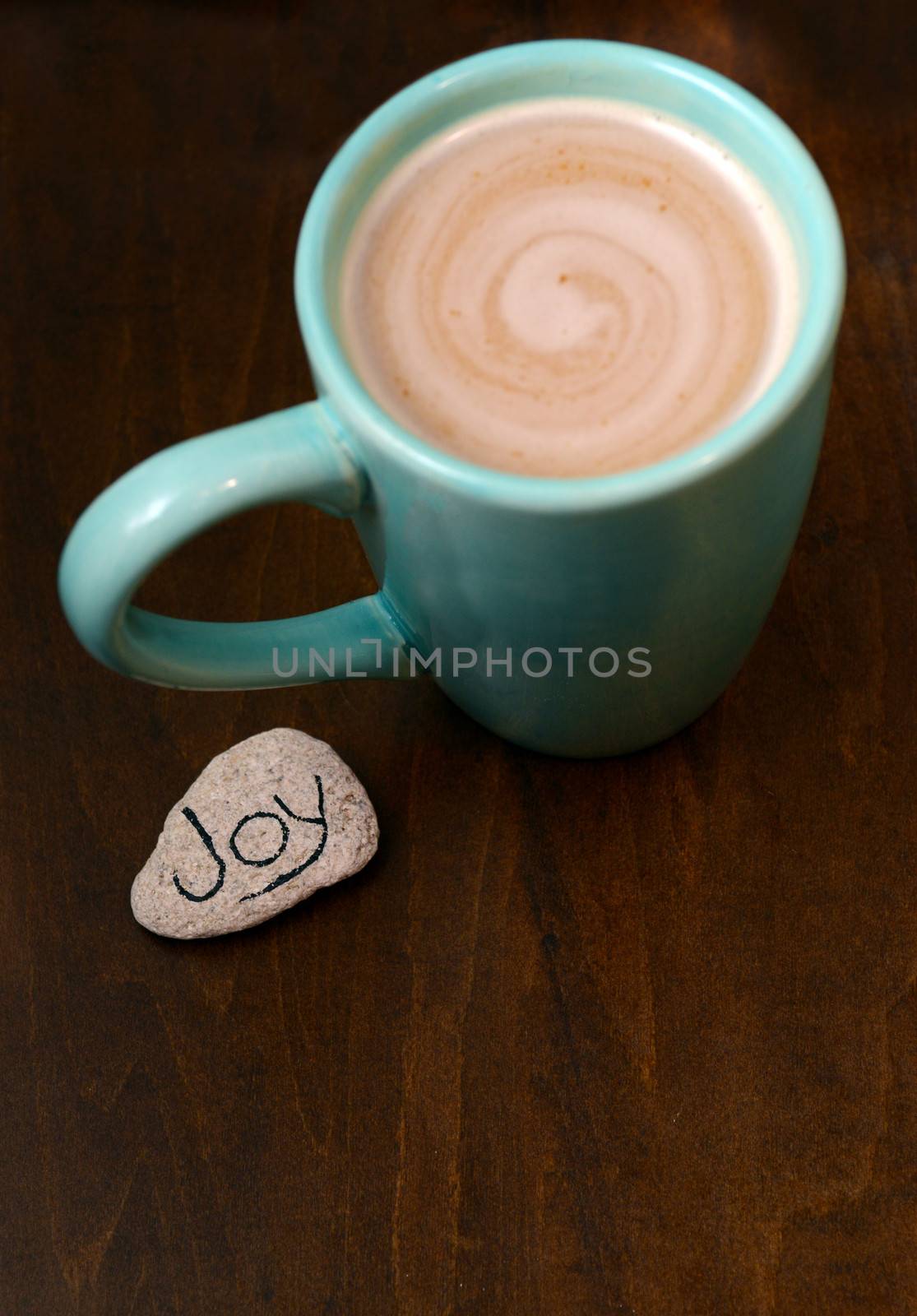 hot chocolate and joy on wood background