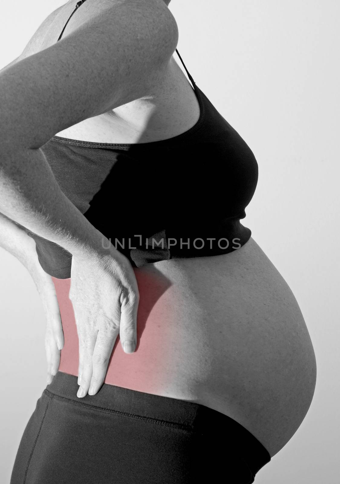 pregnant woman with back pain indicated with red