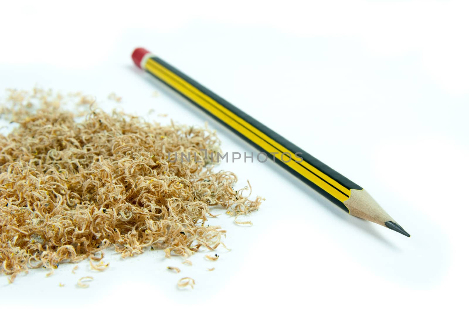 Wooden pencil with shavings isolated on white background