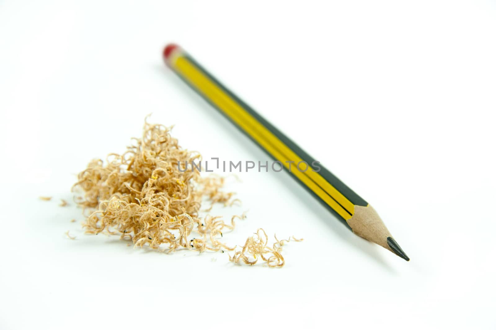 Wooden pencil with shavings isolated on white background