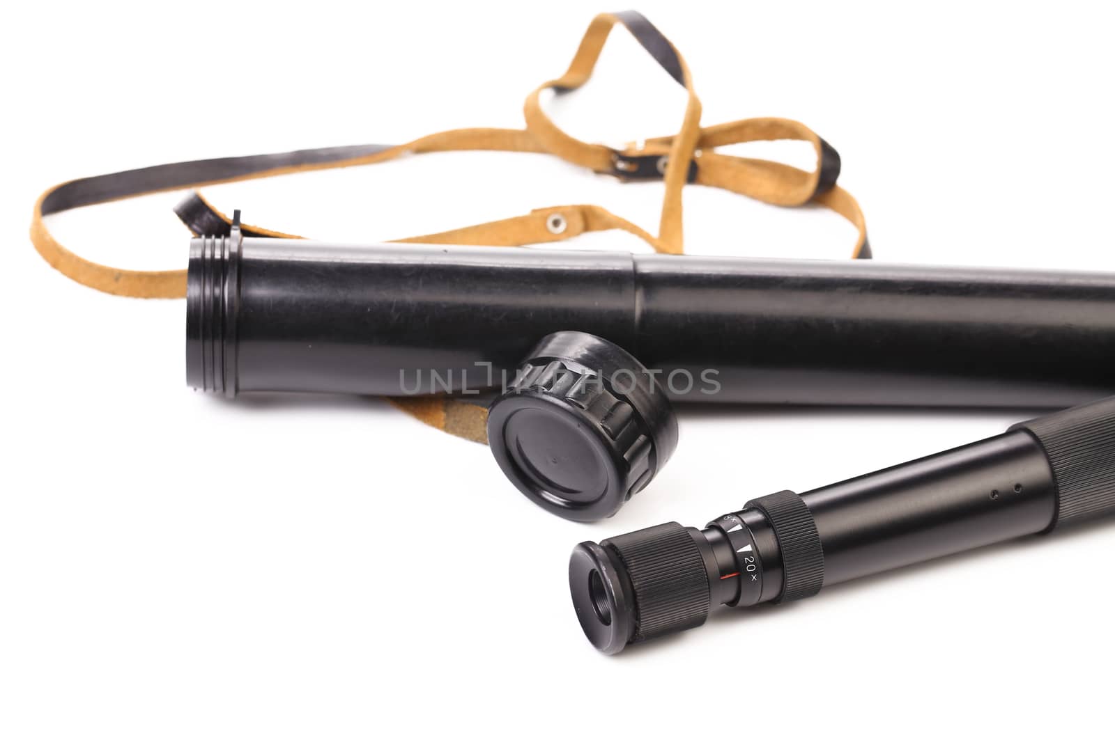 Black cover and spyglass lying. White background.
