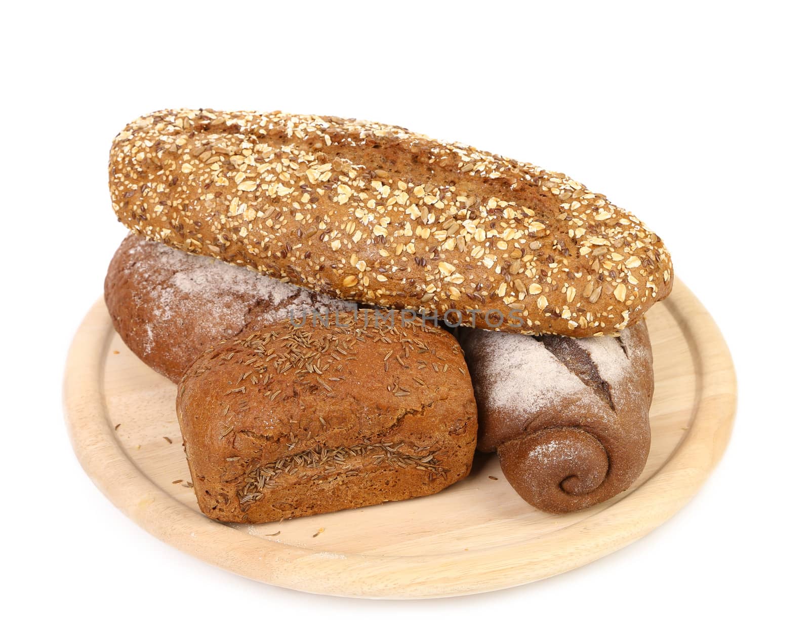 shot of assorted bread in a wooden tray over a white background