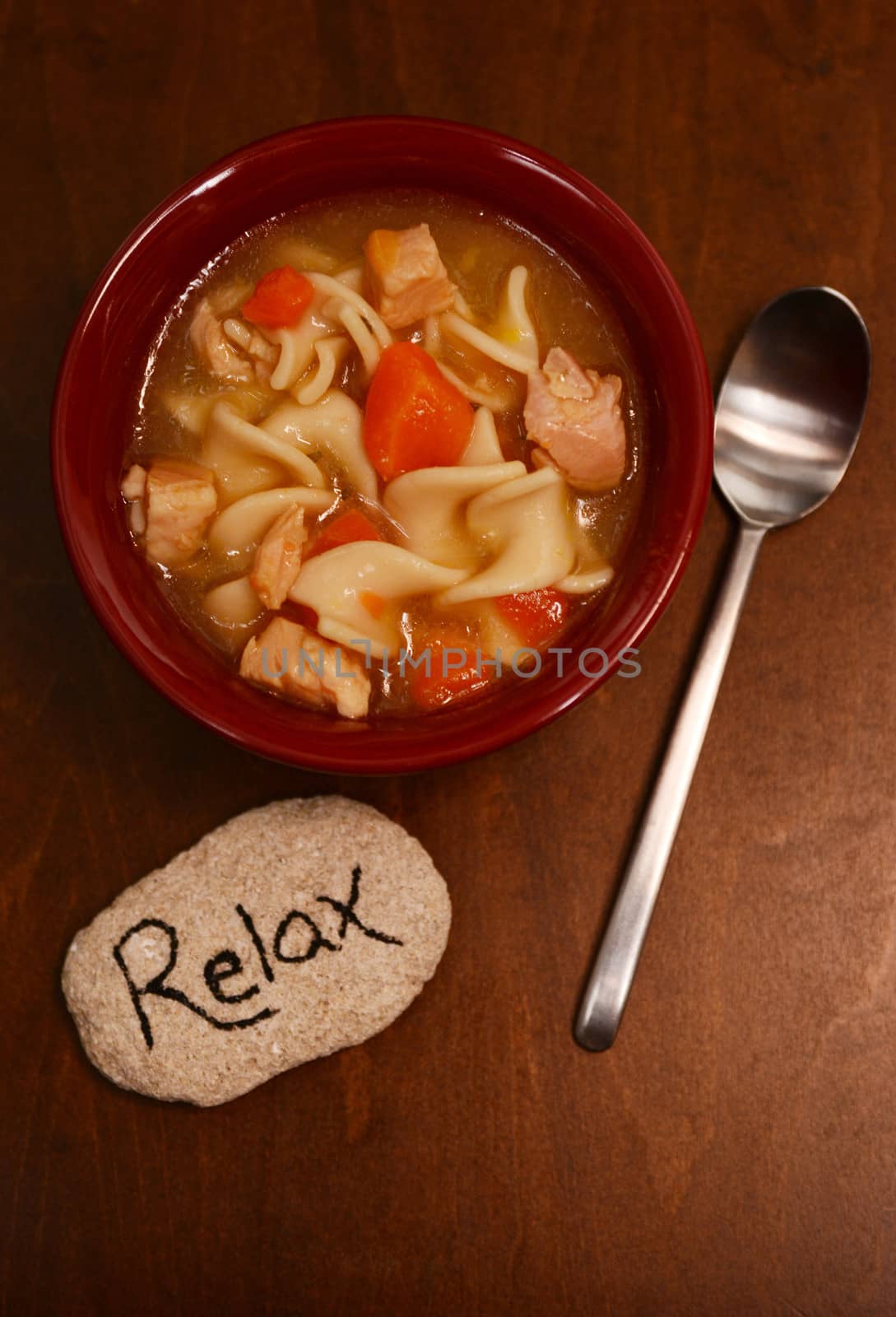 relaxing with hearty bowl of chicken noodle soup 