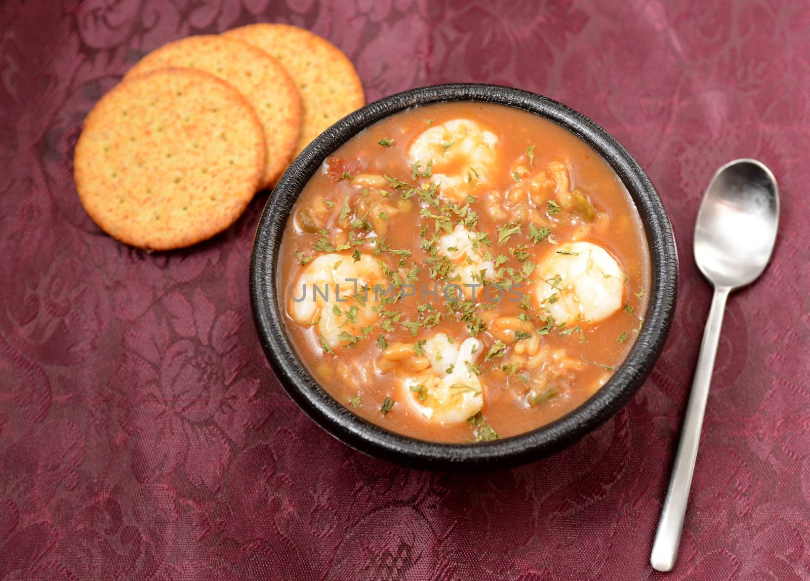 creole shrimp gumbo with crackers at a restaurant