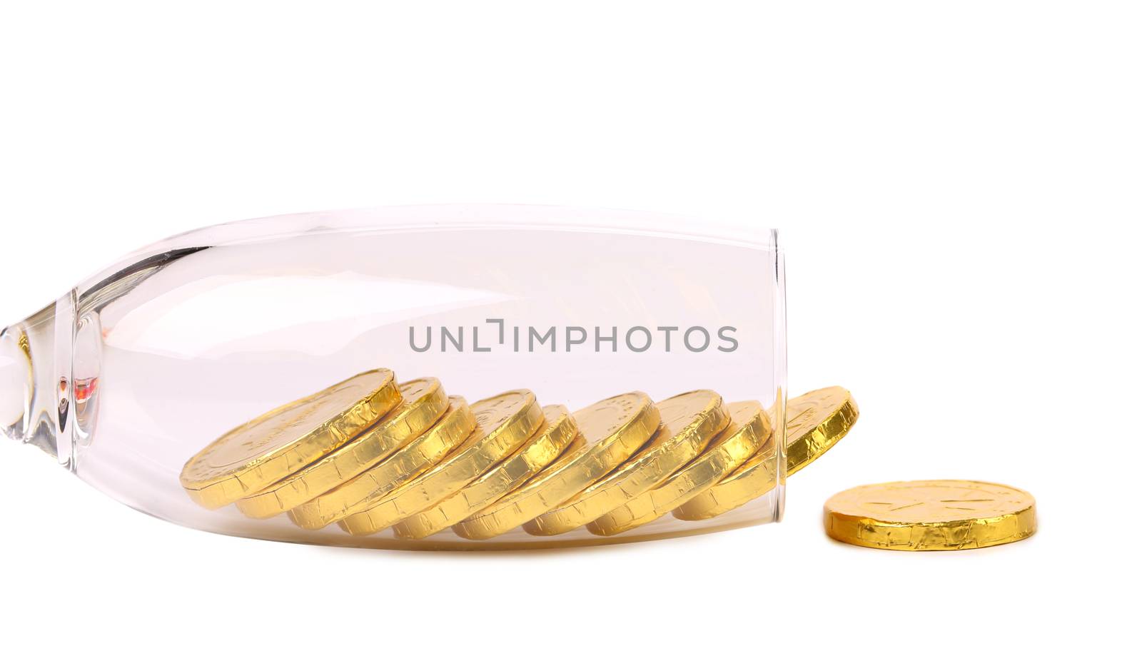 Chocolate coins get out of wineglass. White background.