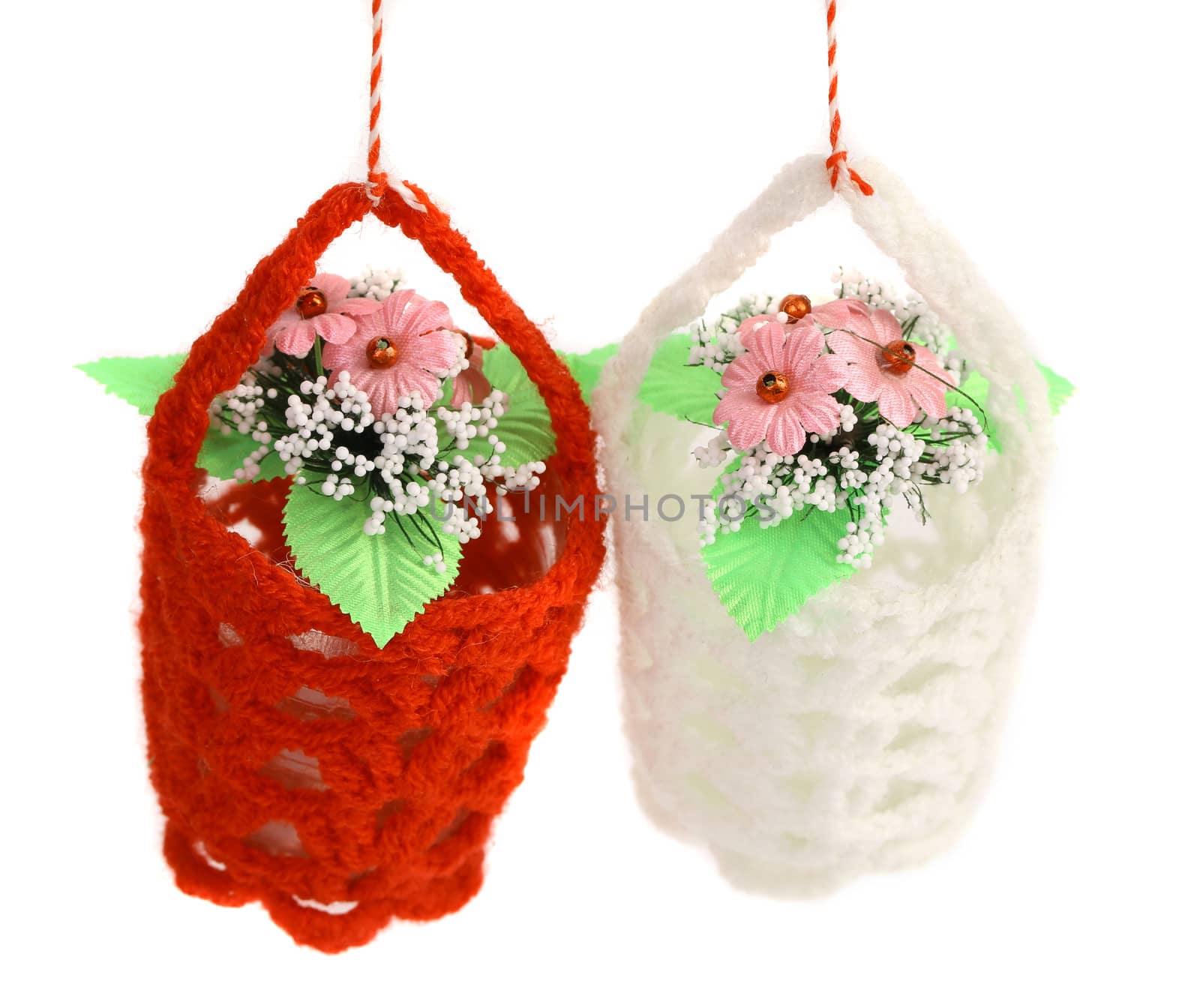 Red and white baskets of flowers. White background.