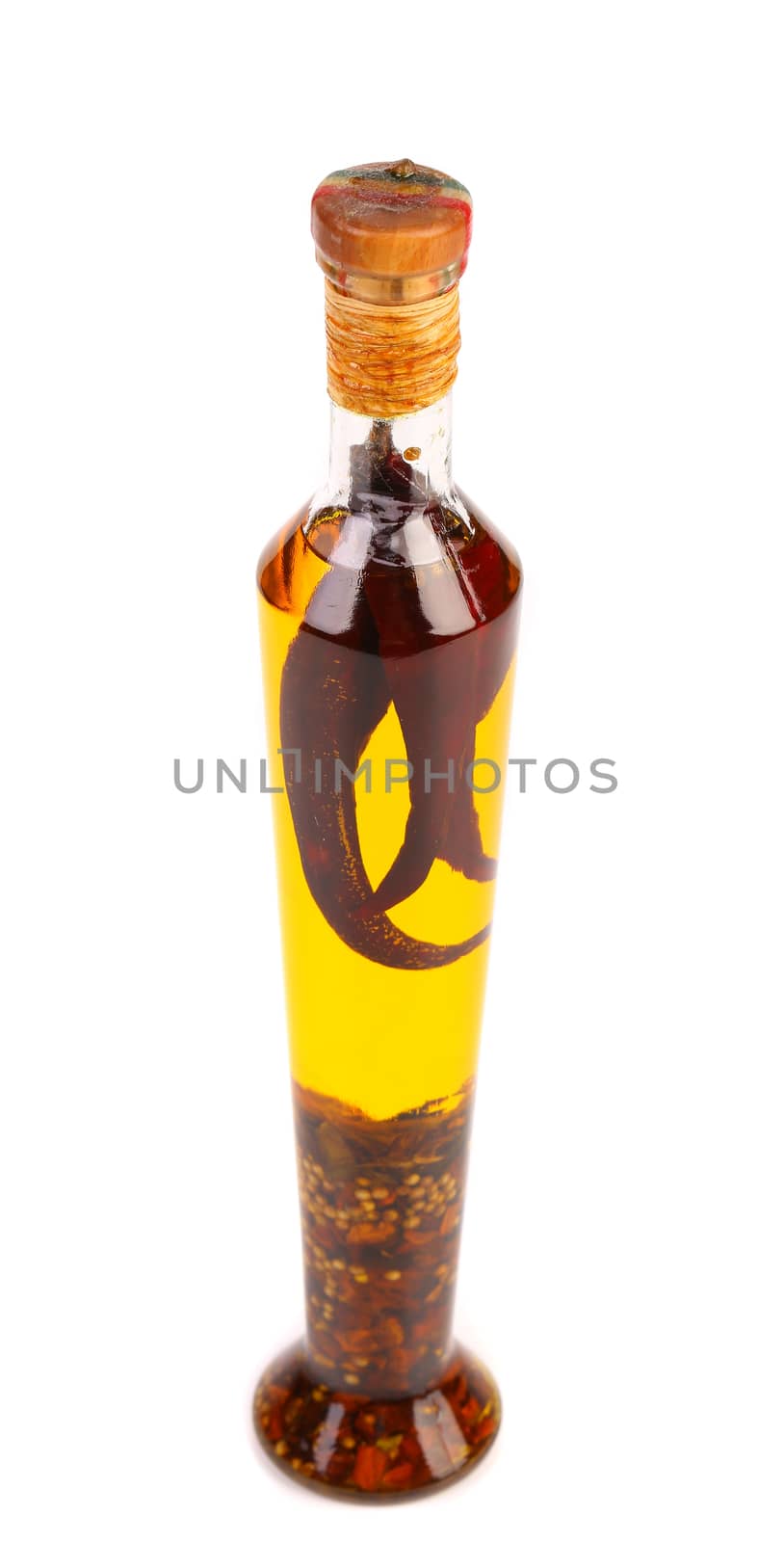 Oil with spicery into bottle. Close up.