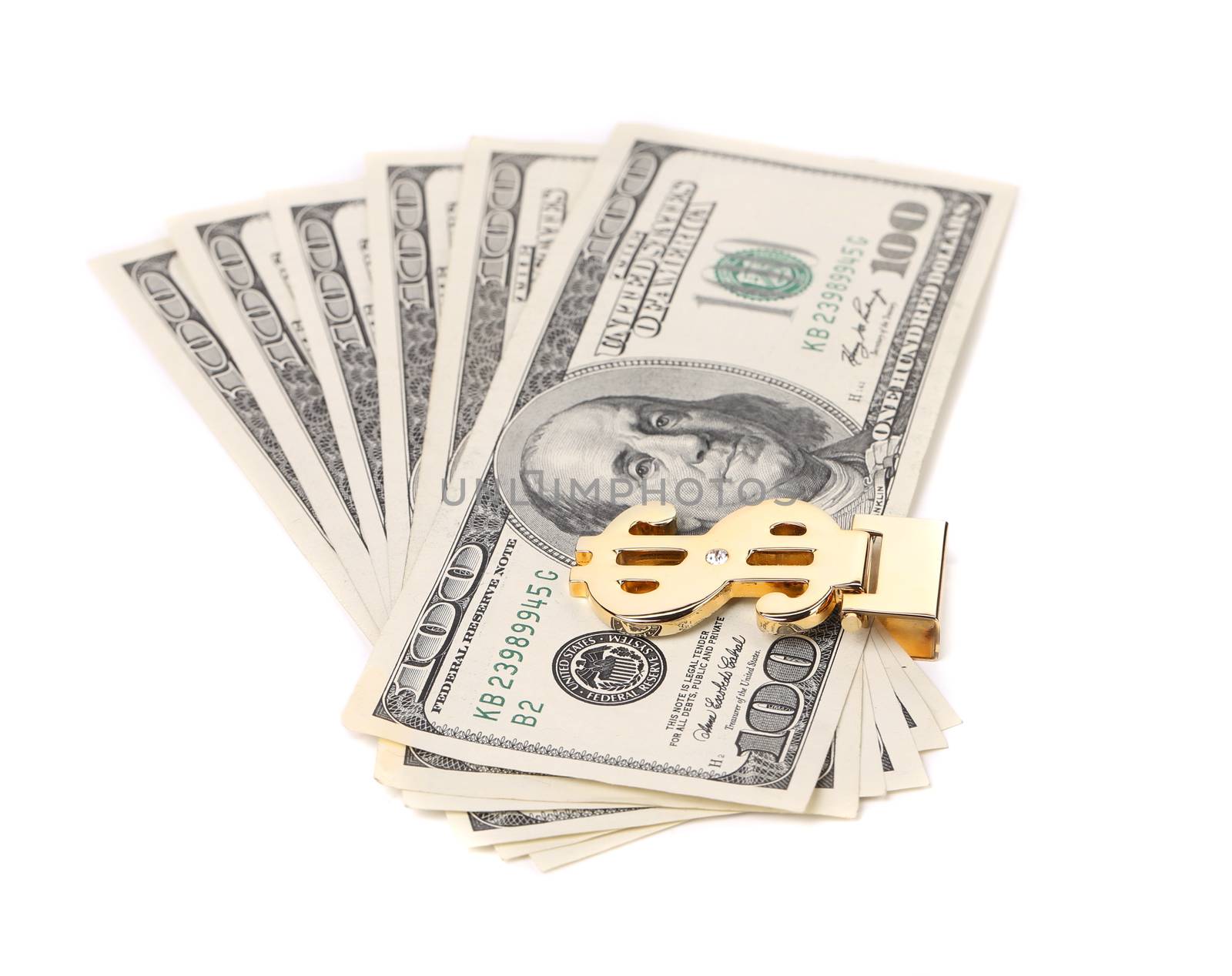 One hundred dollars banknotes in money clip. White background.