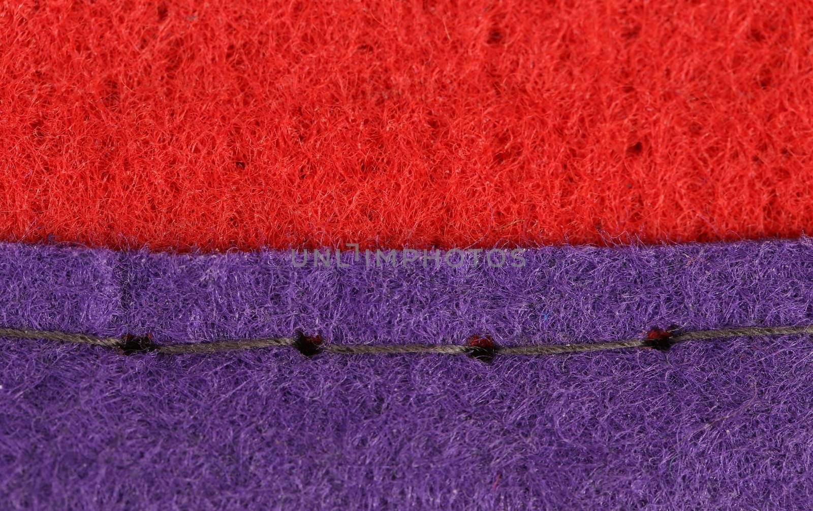 Join of red and blue fabric of artificial fibre.