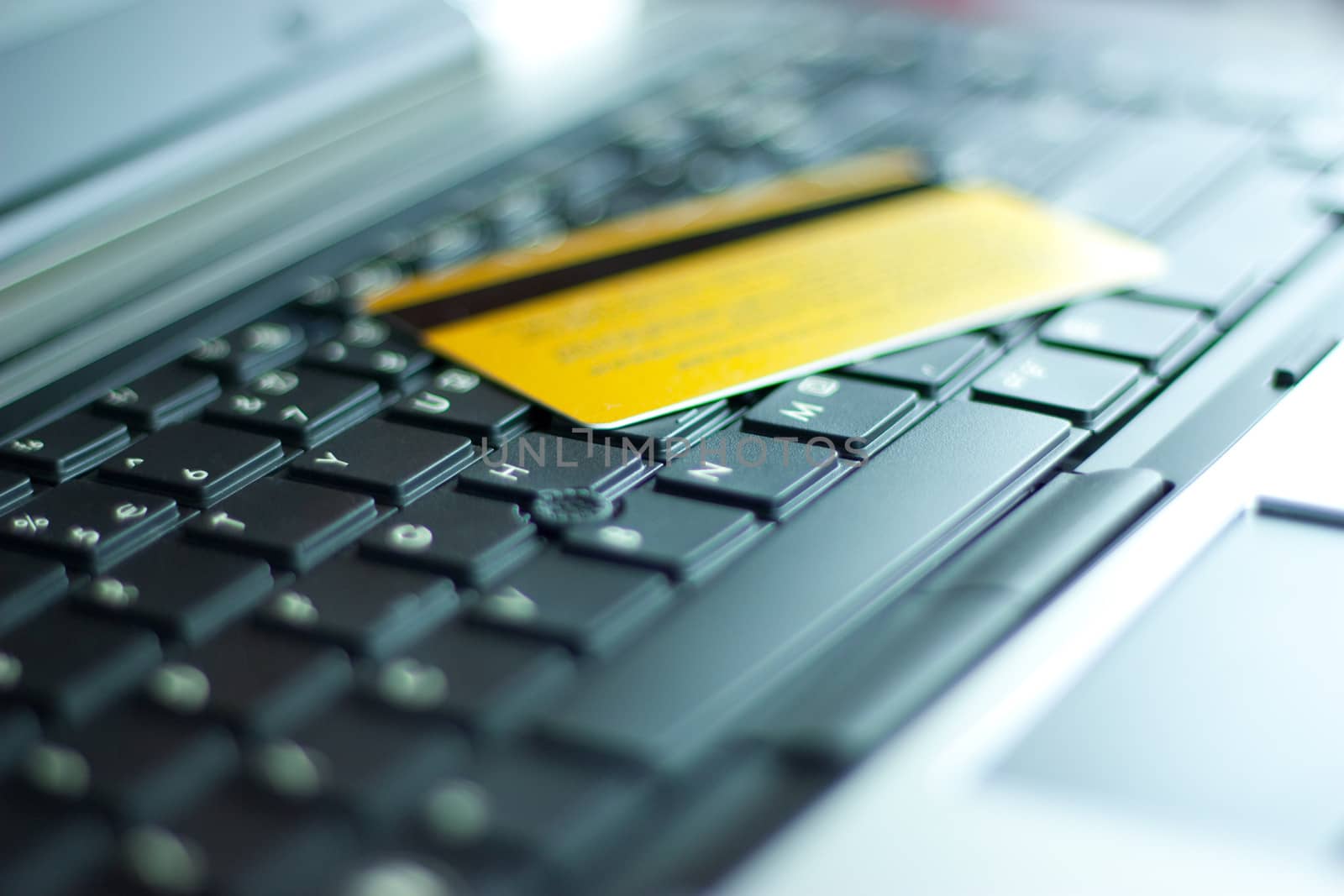 Gold credit card on computer keyboard