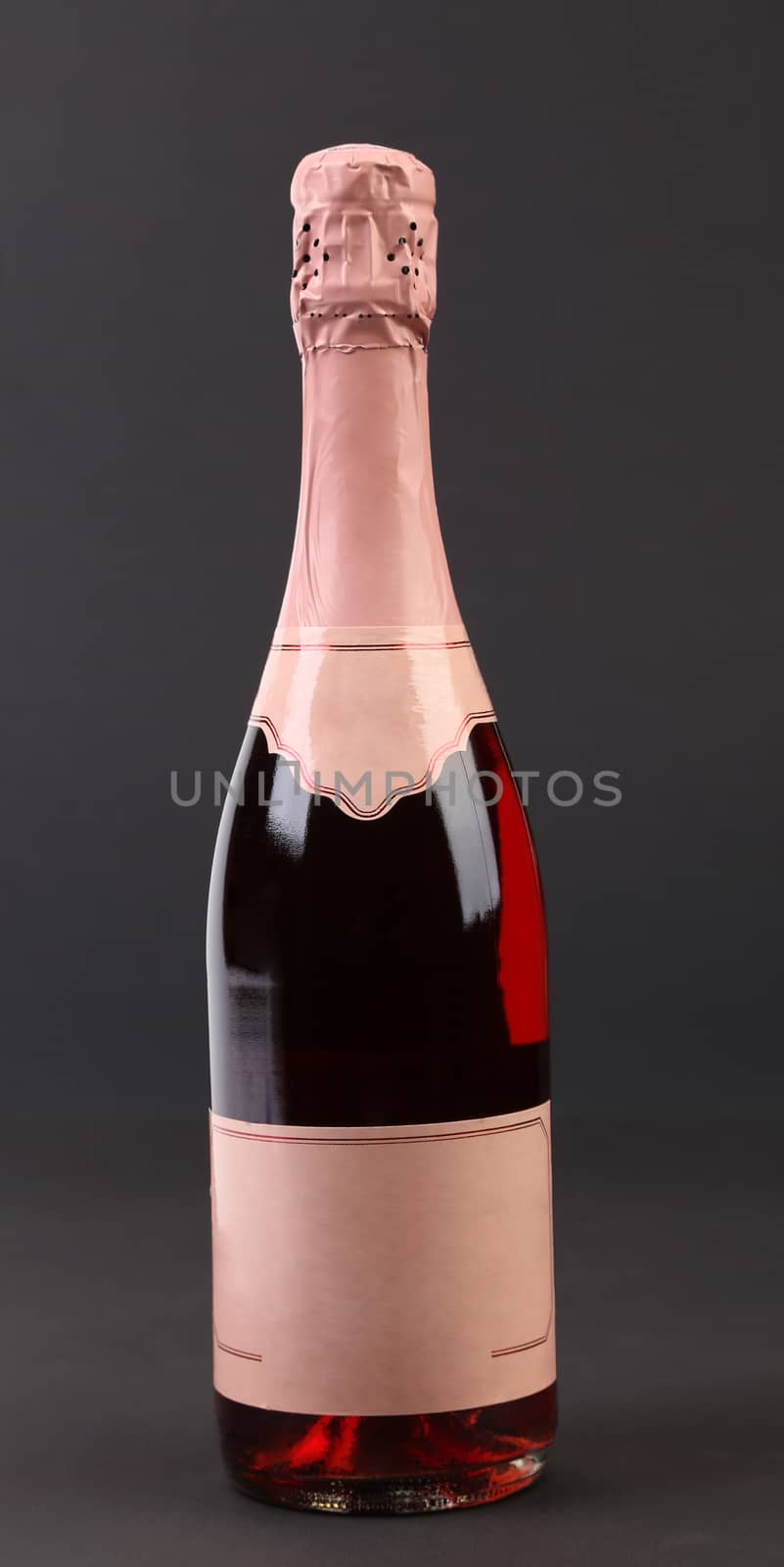 Bottle of pink champange. Isolated on a black background.