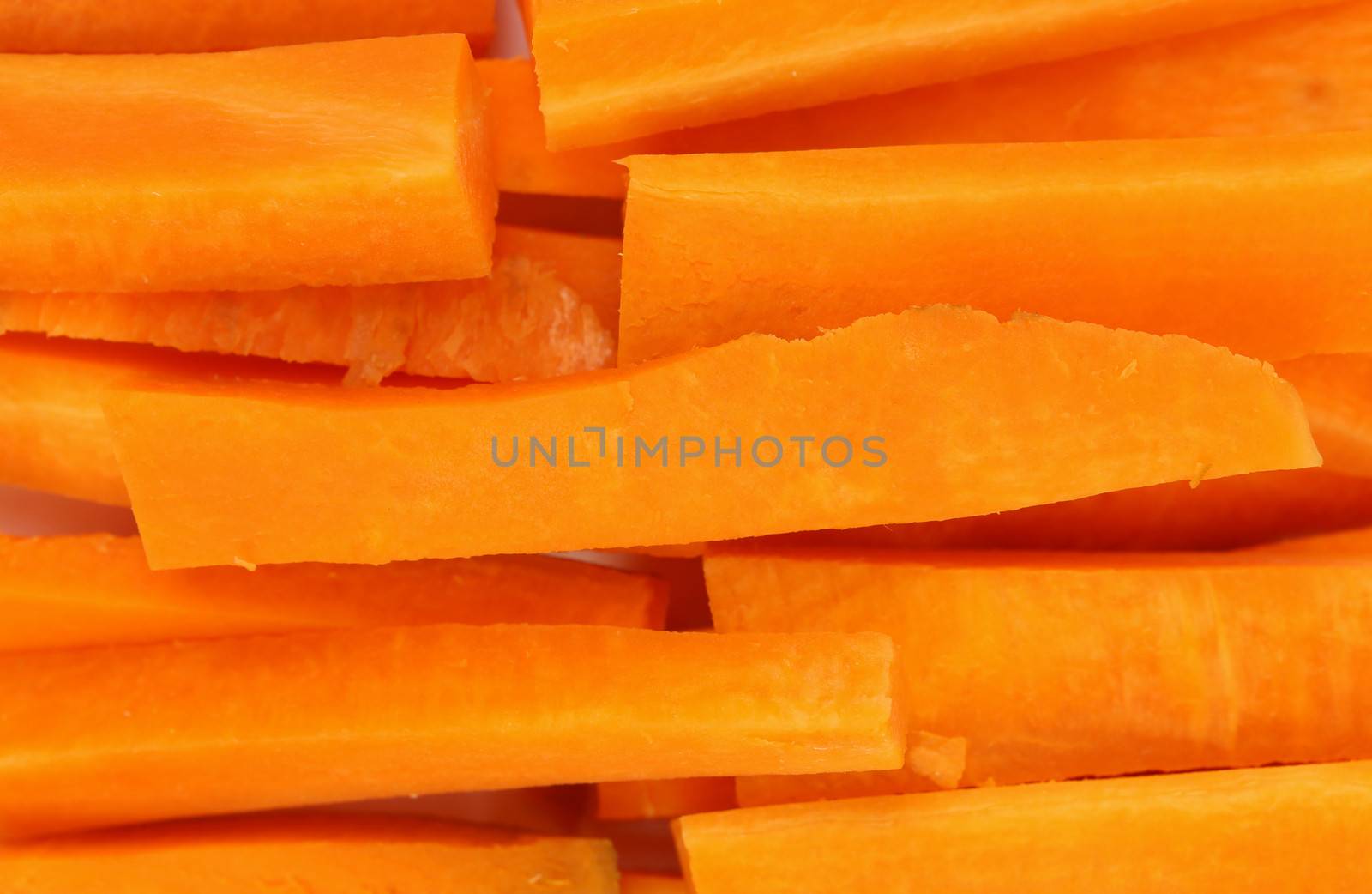 Background of fresh carrots sticks. Close up.