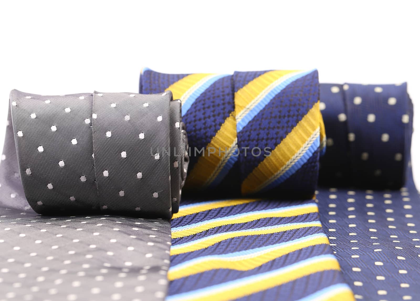 Three rolled up necktie isolated on white background.
