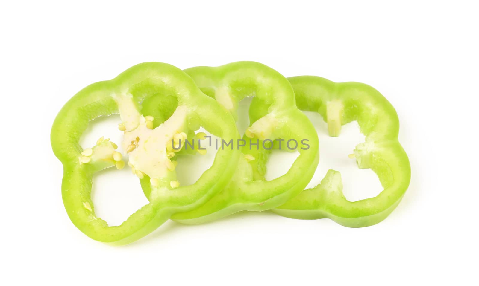 slices of green bell pepper isolated on white background