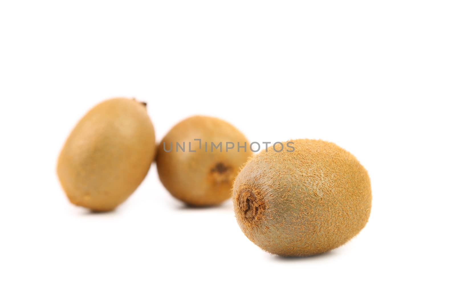 Three fresh kiwi on a white background.