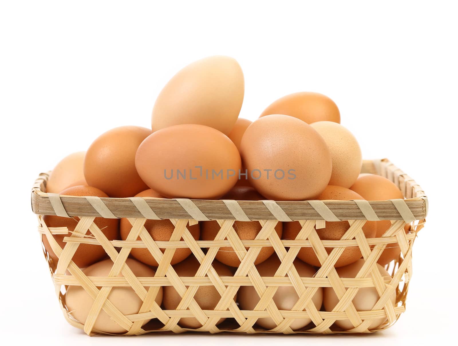 Full basket off eggs. In a white background