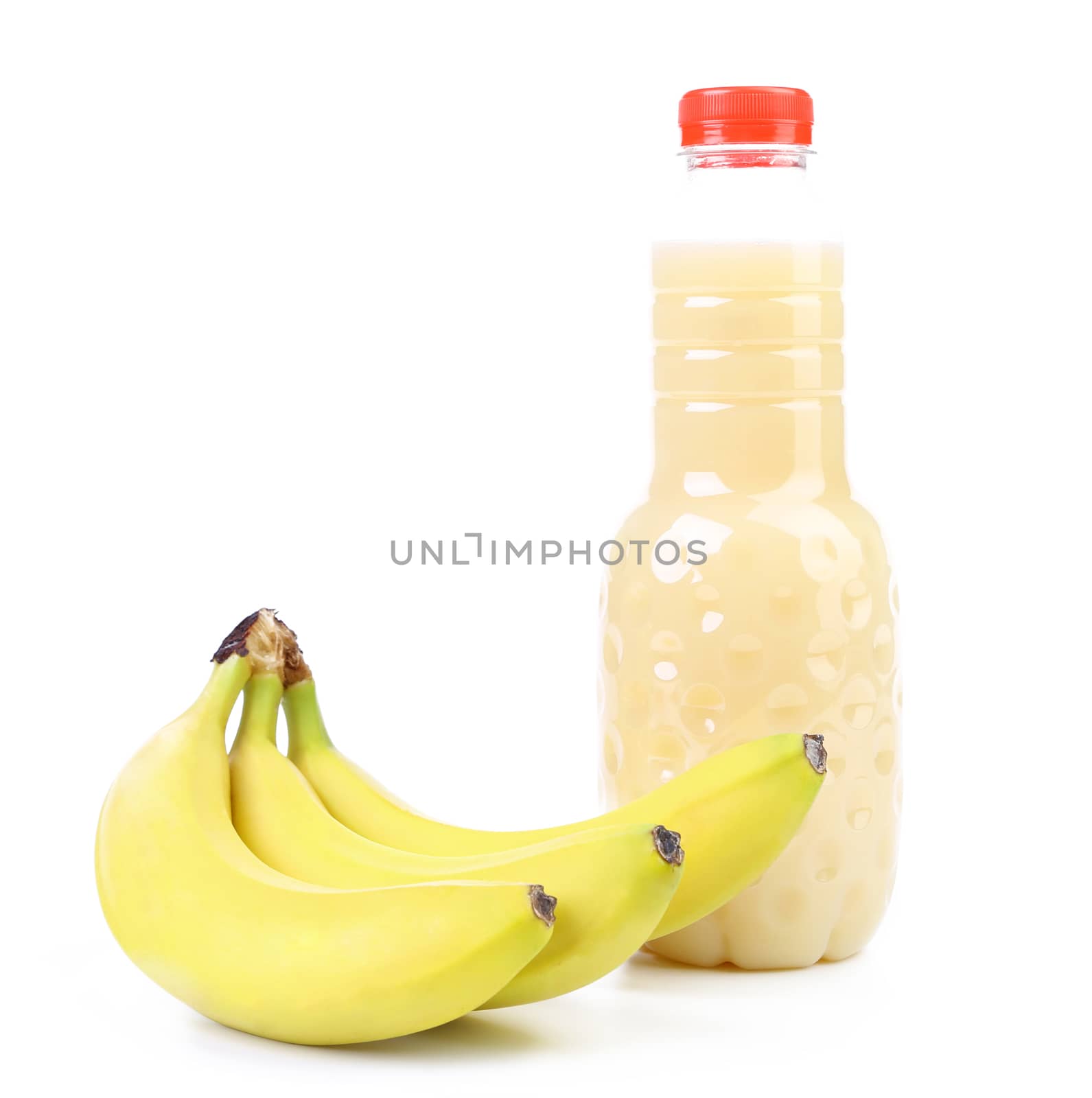 Banana and bottle of juice. On a white