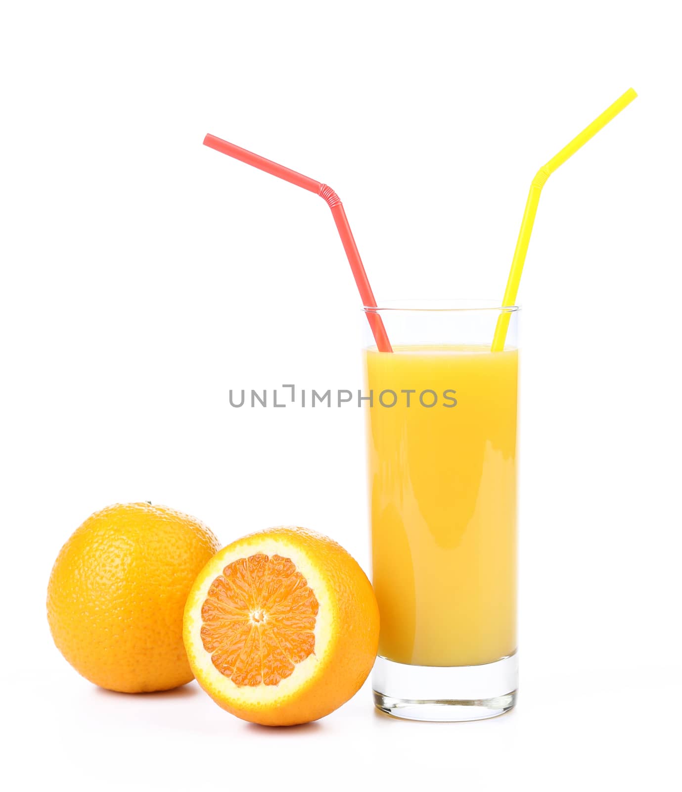Orange juice with staw and two oranges cut and whole