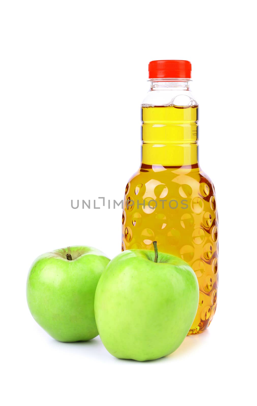 Apple juice in plastic bottle and two apples on a white