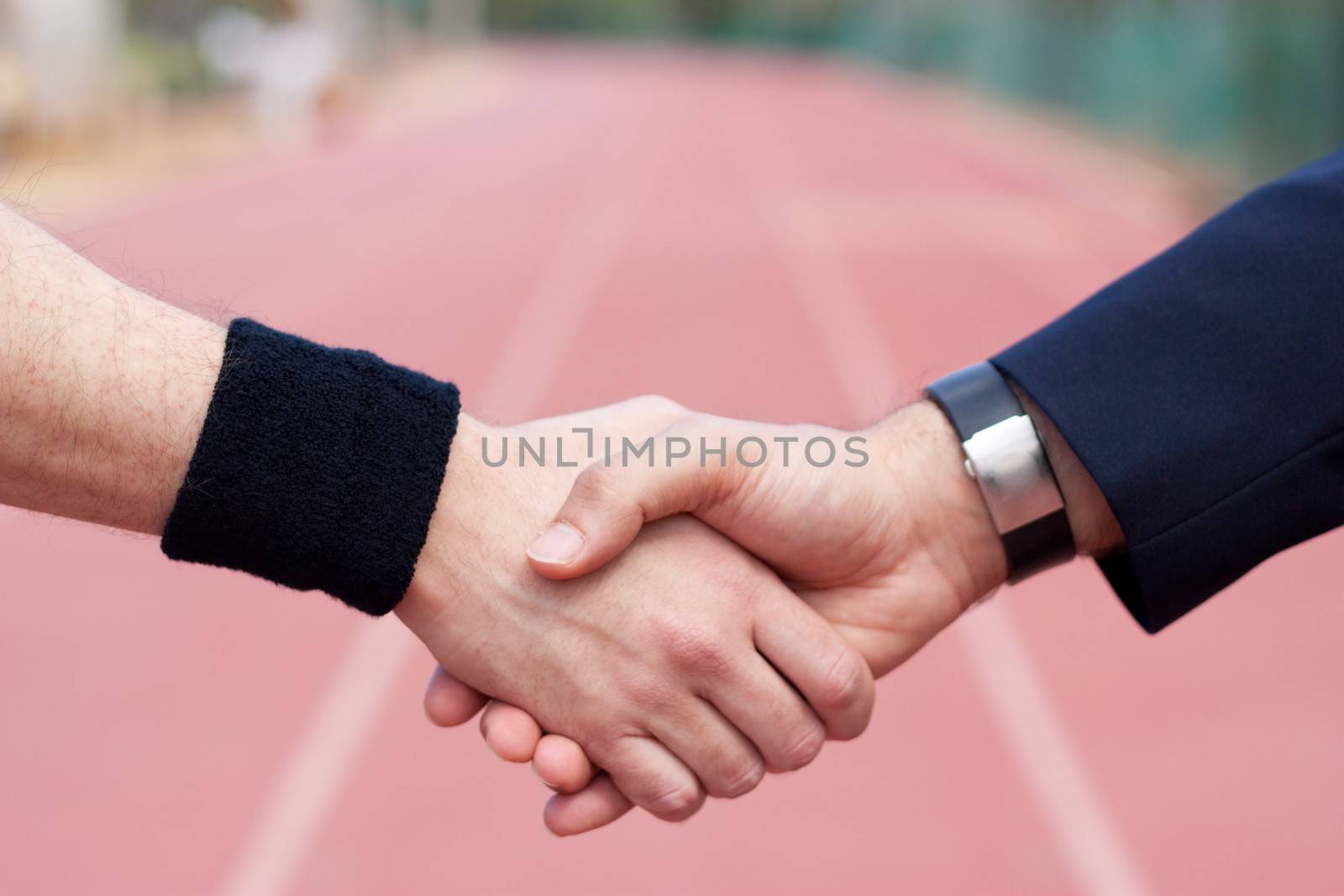 Shaking hands on running track