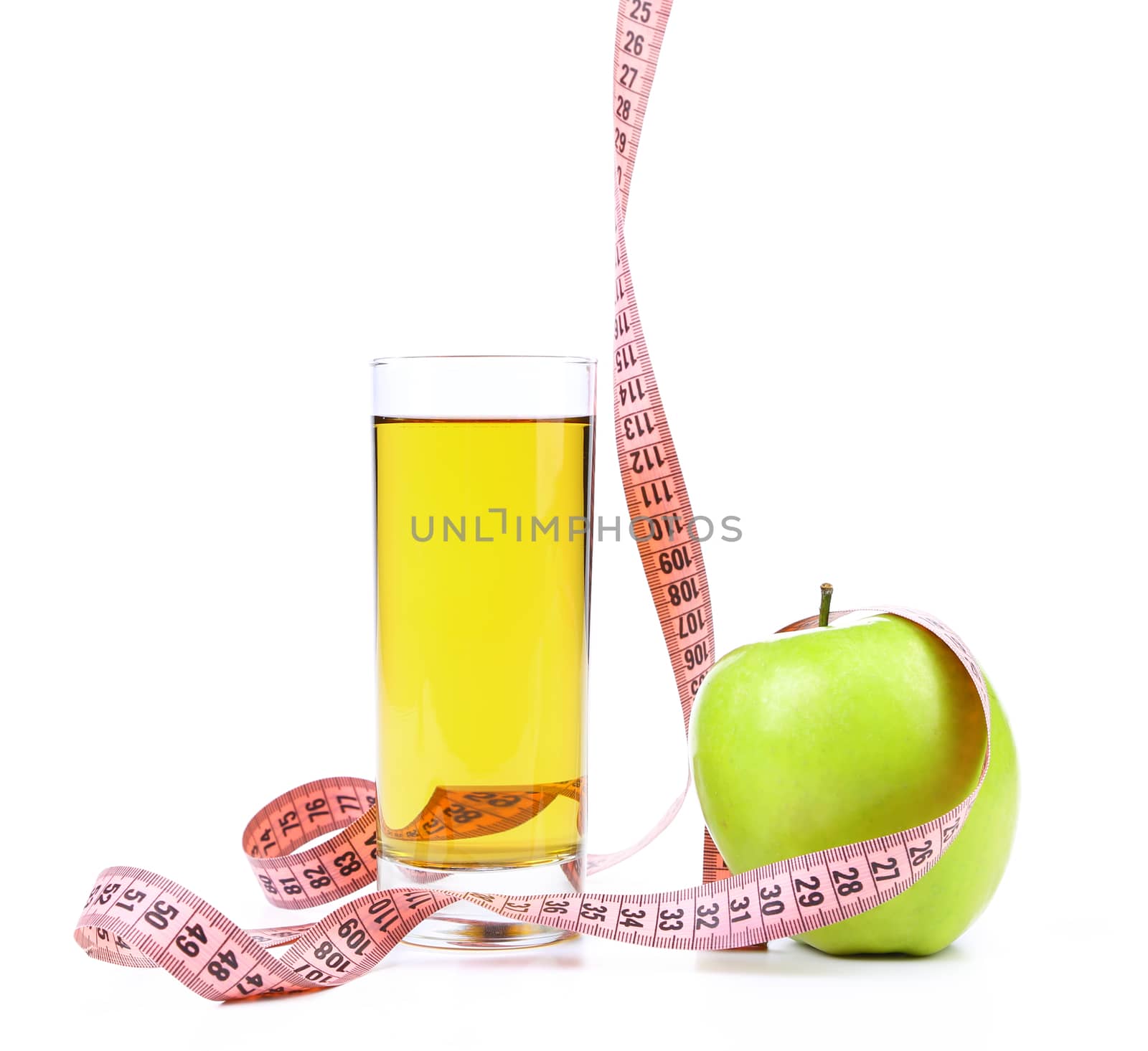 Green apple with juice and tape measure. On a white background