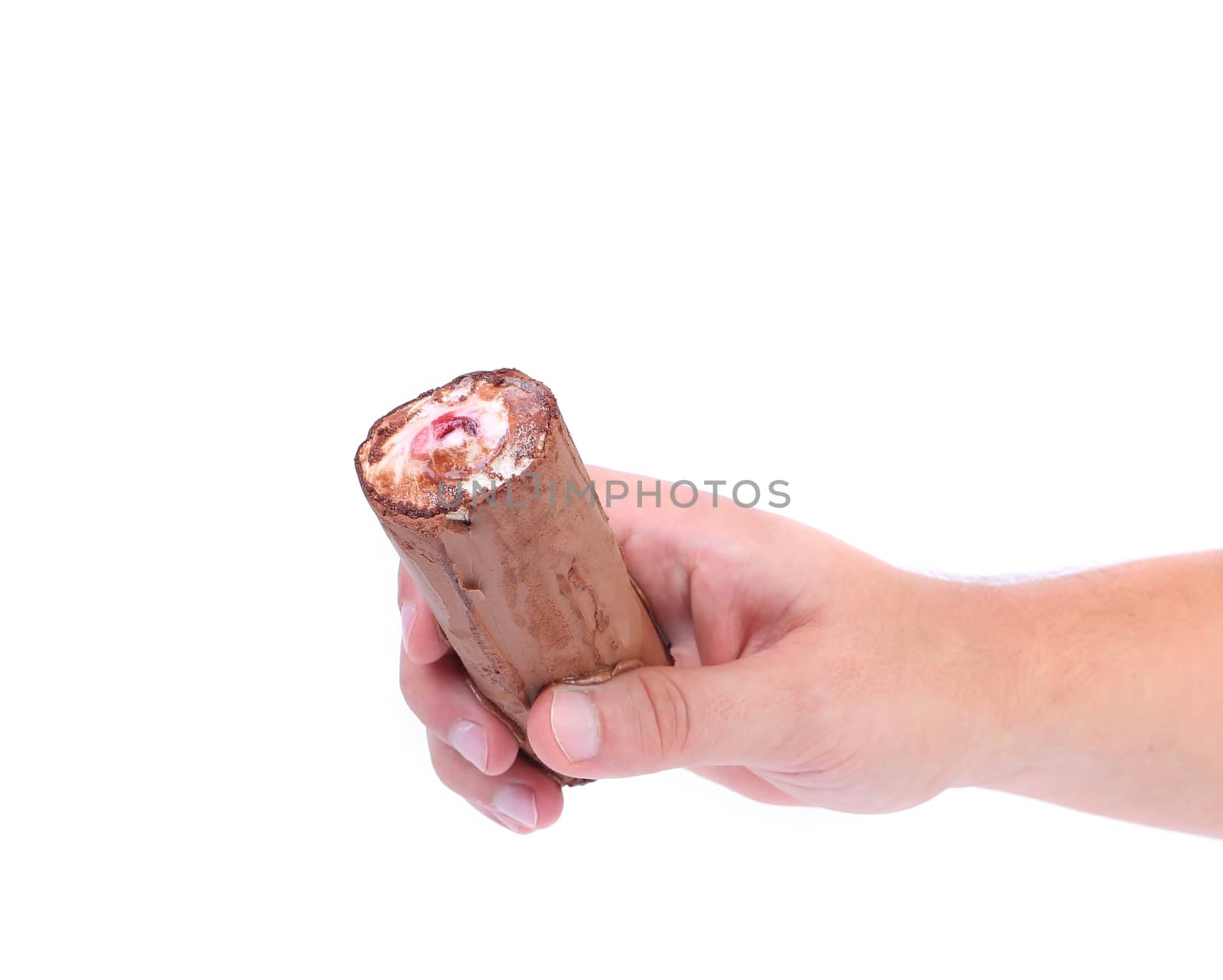 Hand holds roll of chocolate ice cream. White background.