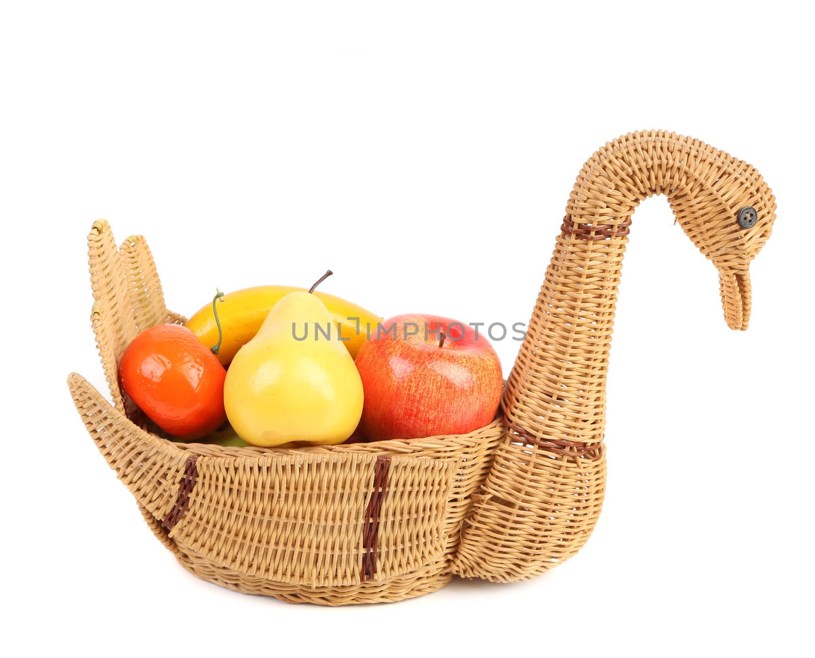 Artificial fruits in wicker basket isolated on white background