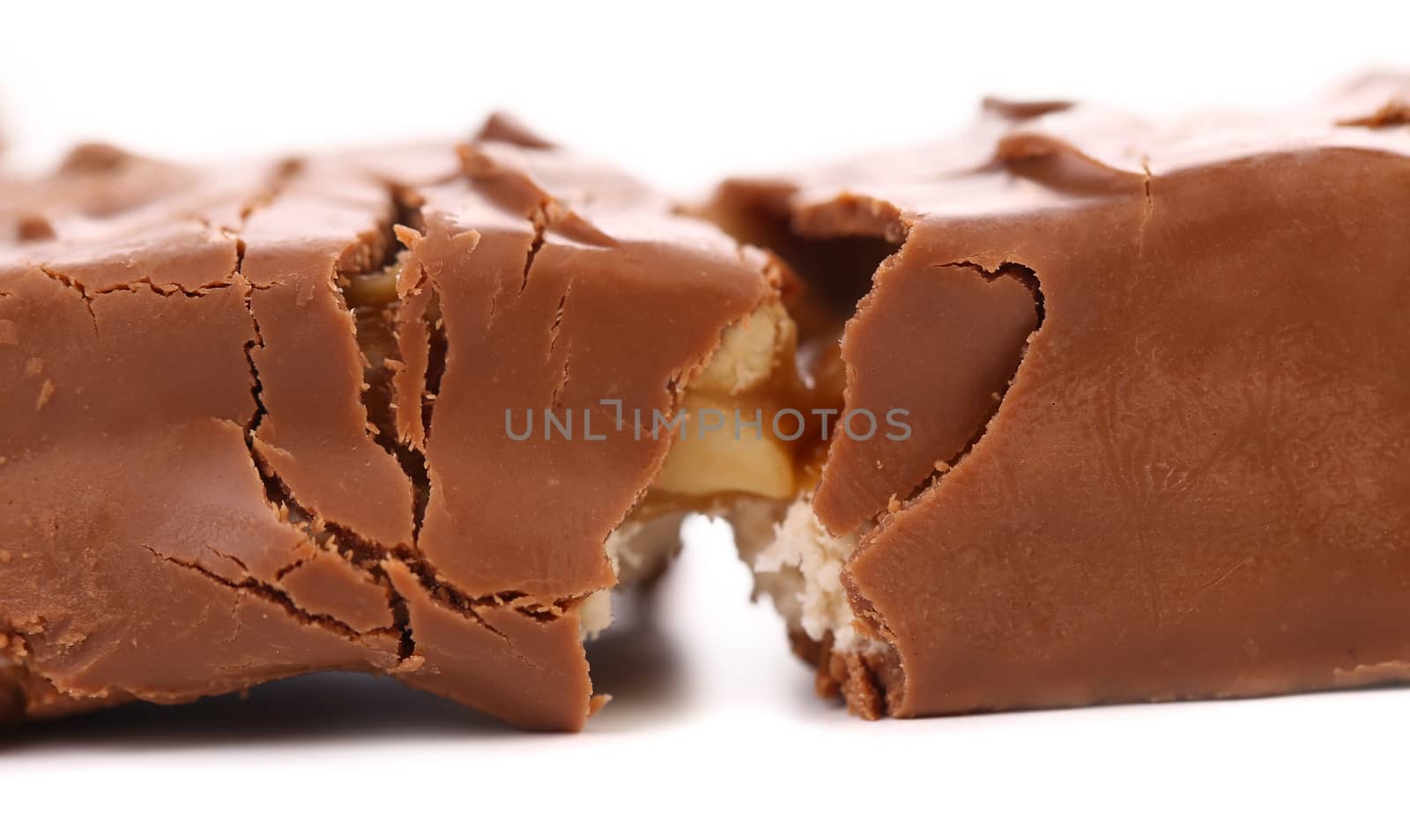 Broken chocolate bar with filling. White background.